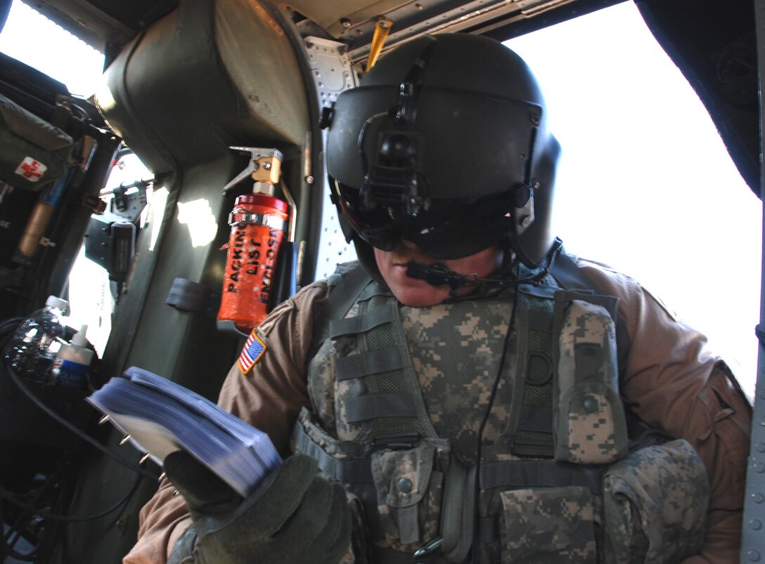 Army Sgt. Jared Squires reviews his pre-flight checklist Jan. 4, 2008. After conquering cancer, Squires joined his unit deployed to Iraq. Photo by Pfc. Monika K. Smith, USA