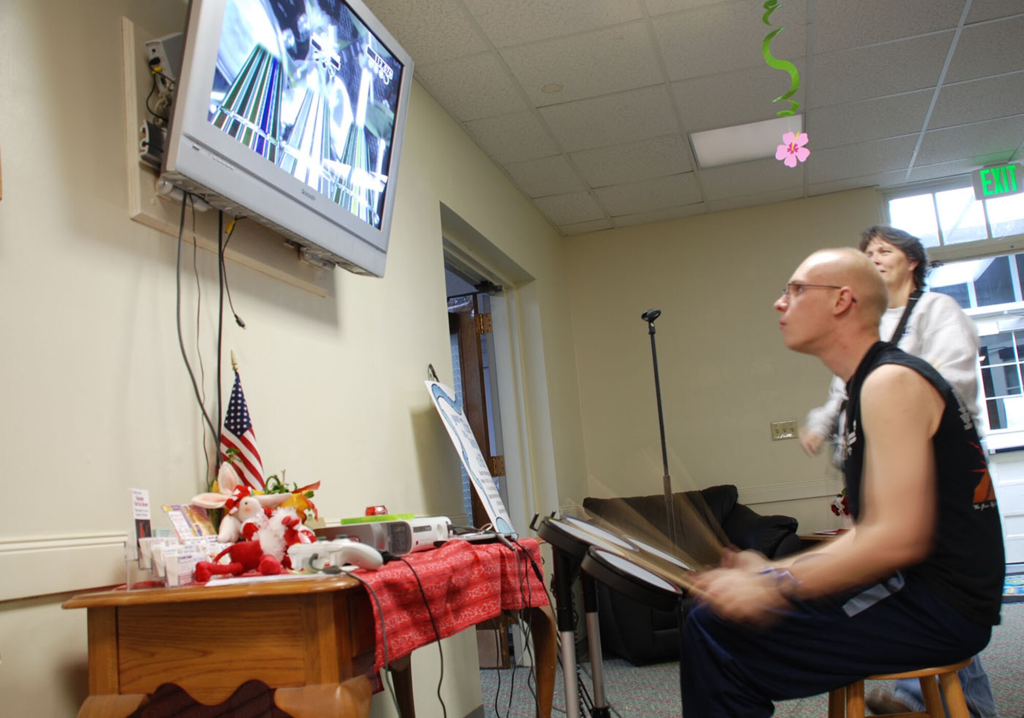 Airman 1st Class Clinton Field, 90th Maintenance Group, and Tara Morton, Fall Hall Community Center director, play a musical video game during the “Fantasy Island” Airman Late Nighter. The party began at 9 p.m. and lasted until 1 a.m (U.S. Air Force photos/Airman 1st Class Daryl Knee).