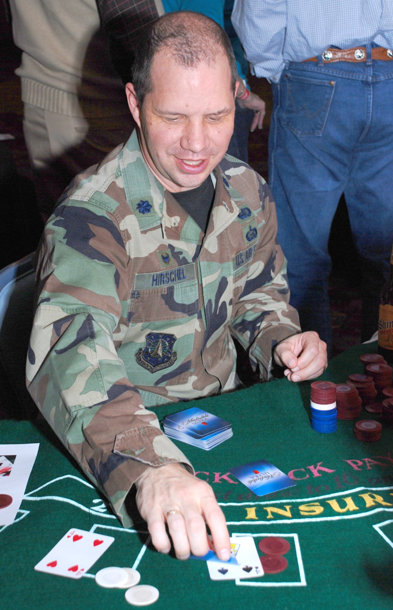 Lt. Col. Carleton Hirschel, 90th Force Support Squadron commander, deals to players at the blackjack table Jan. 4. Attendees gambled with fake paper money.