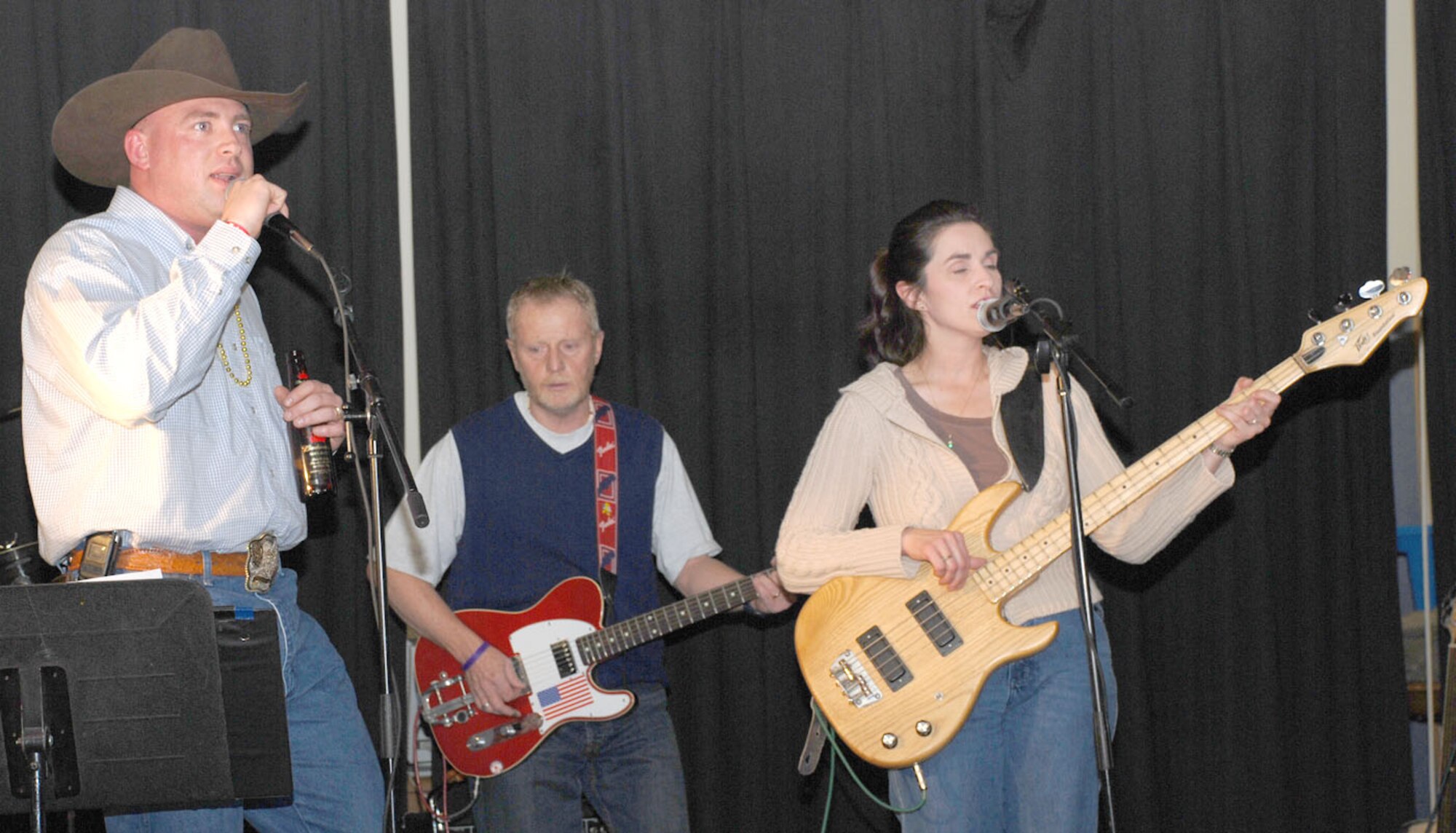 Tech. Sgt. Kenny Kindrick, 90th Logistics Readiness Squadron and Warren Idol contestant, performs as a guest singer for Ty and the Twisters during the Should Have Been New Year’s party. Ty and the Twisters is made up of Mark Warner, guitarist from the education office, Brenda Patch, bass guitarist, and Paul Hansen, drummer.