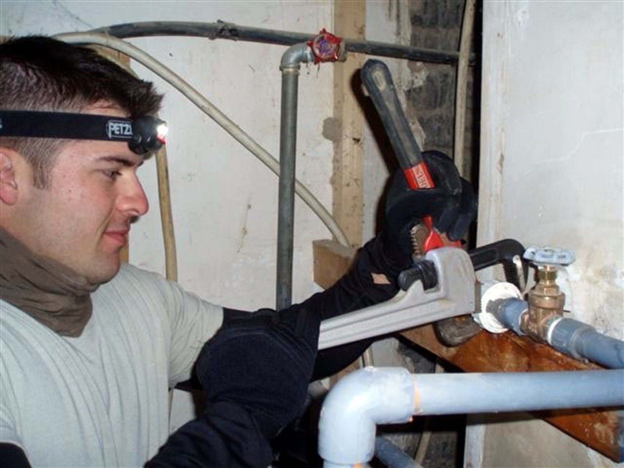 Staff Sgt. Caleb Dennis fixes a pipe leak Jan. 11 at Patrol Base Olson, Iraq. Sergeant Dennis, a 732nd Expeditionary Civil Engineer Squadron Det. 6 fuels technician, is deployed from Kadena Air Base, Japan. (U.S. Air Force photo)