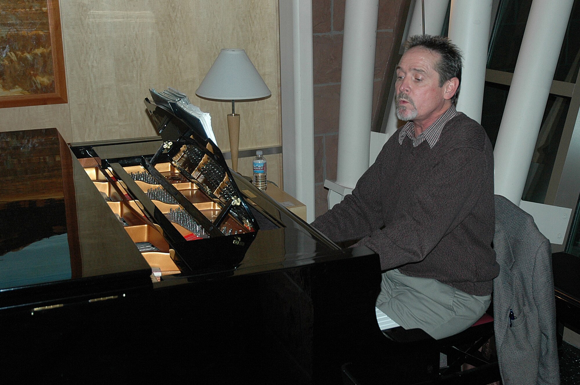 Terry Morris, 532nd Landing Gear Squadron Director, sings and plays a nine-foot Yamaha grand piano at the McKay-Dee Hospital Center in Ogden. Mr. Morris is part of the McKay-Dee Piano Guild, a volunteer organization with more than 80 members, several of which are from Hill Air Force Base. (U.S. Air Force Photo by Fred Schoettler)