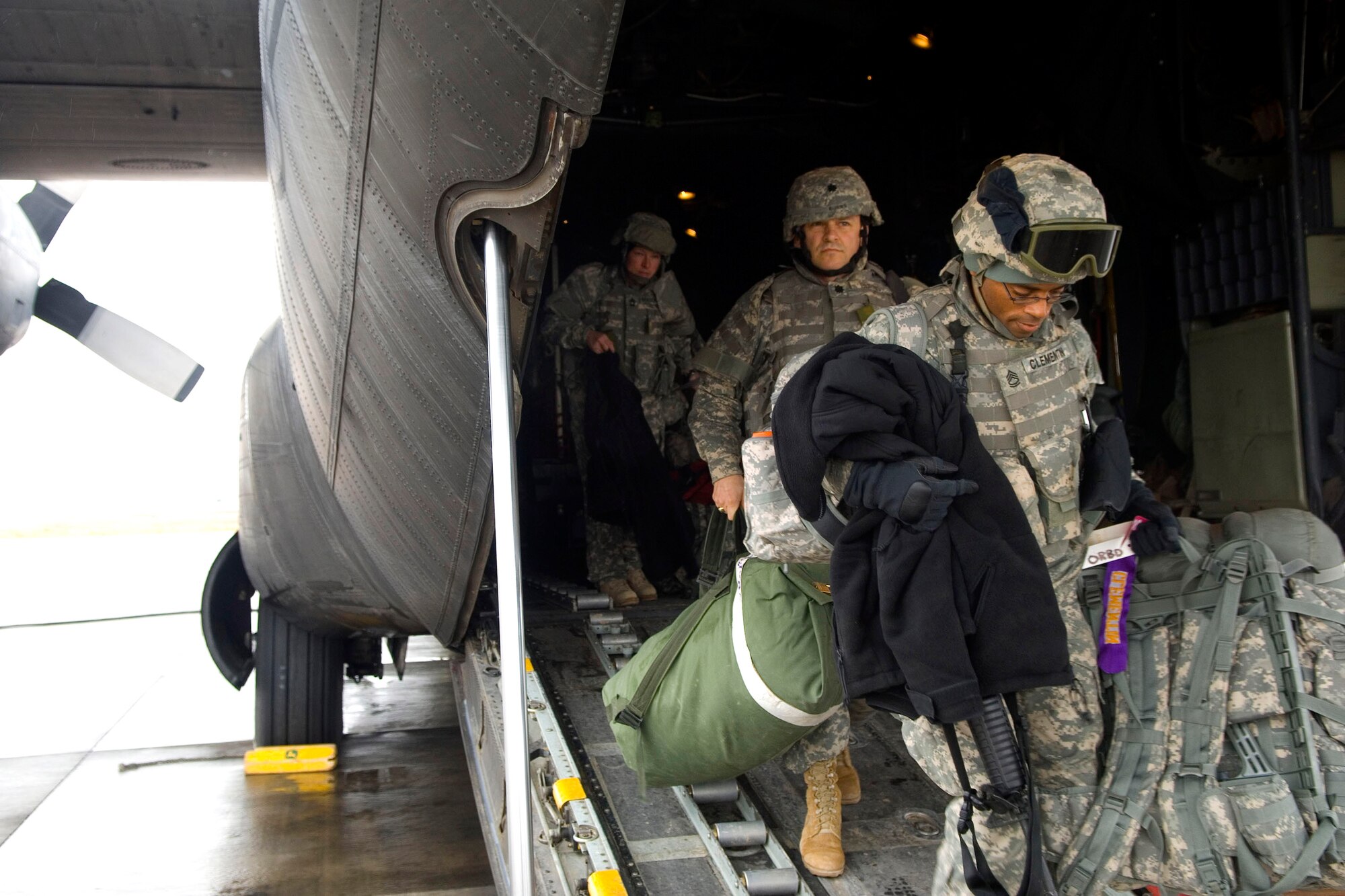 Airmen and Soldiers exit a C-130 Hercules Jan. 11 at a Southwest Asia air base. The C-130 mission in Iraq is to provide precision air delivery of supplies and personnel throughout the theater of operations. (U.S. Air Force photo/Staff Sgt. Travis Edwards)