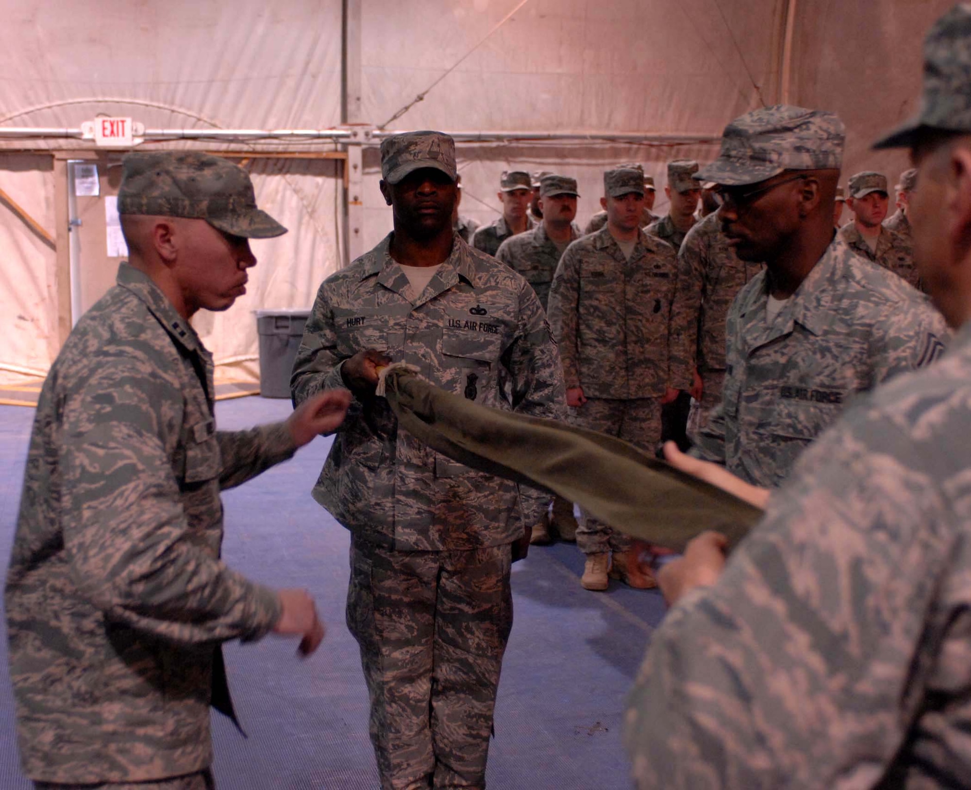 The 755th Expeditionary Security Forces Squadron guidon is cased Jan. 11 at Bagram Air Base, Afghanistan. The squadron, originally formed in May 2006 in response to a Army request for support of its detainee operations mission, was inactivated during a formal ceremony Jan. 11 here. (U.S. Air Force photo/Staff Sgt. Mike Andriacco) 
