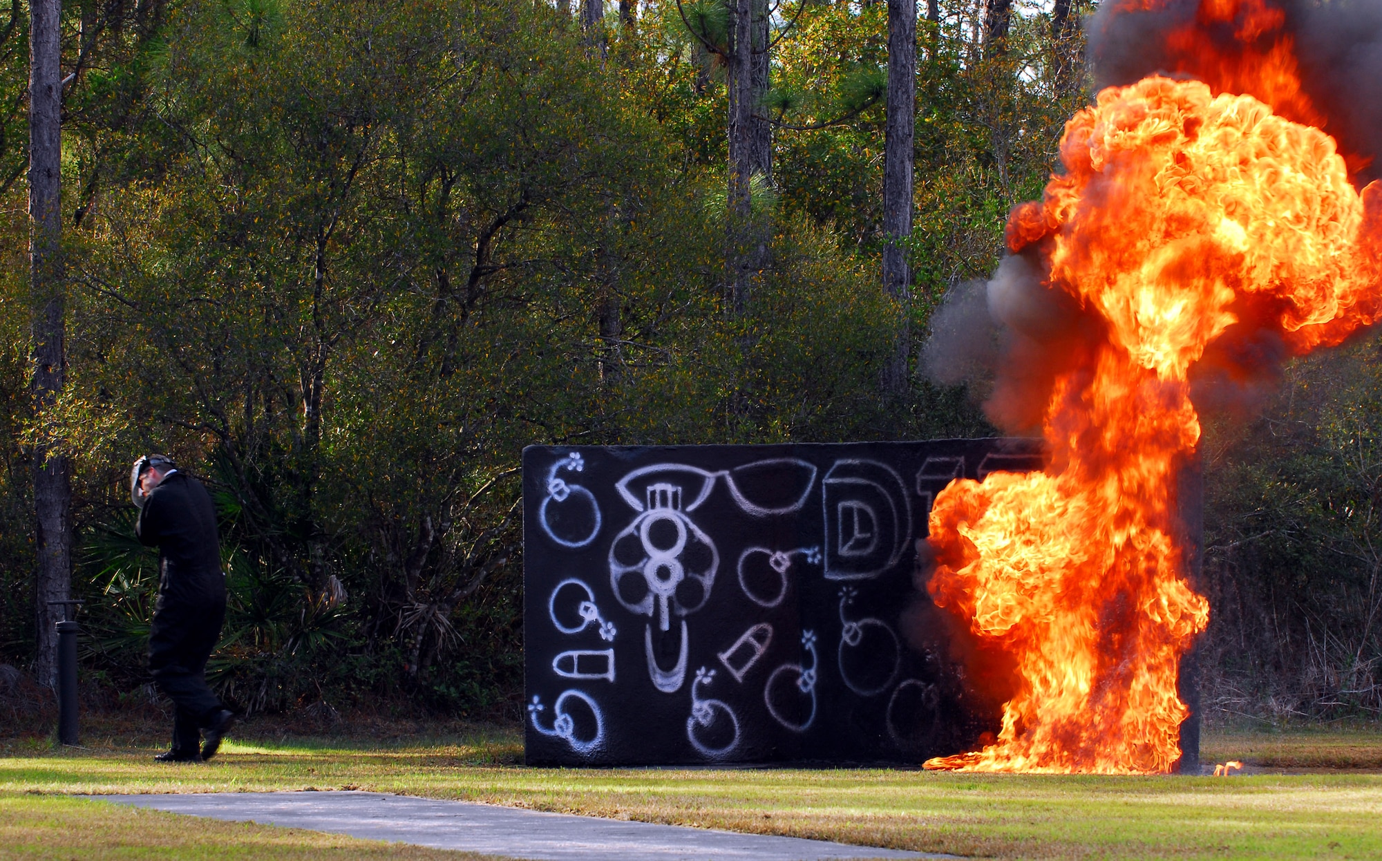 Tech. Sgt. Brian Gilliland reacts to a Molotov cocktail bomb during the explosives effect demonstration Jan. 9 on the Dynamics of International Terrorism range at Hurlburt Field, Fla. The demonstration showed students the capabilities of weapons primarily used by terrorist groups. Students from all branches of the U.S. military participated in the course. Sergeant Gilliland is assigned to the Air Force Special Operations School. (U.S. Air Force photo/Airman 1st Class Jason Epley)