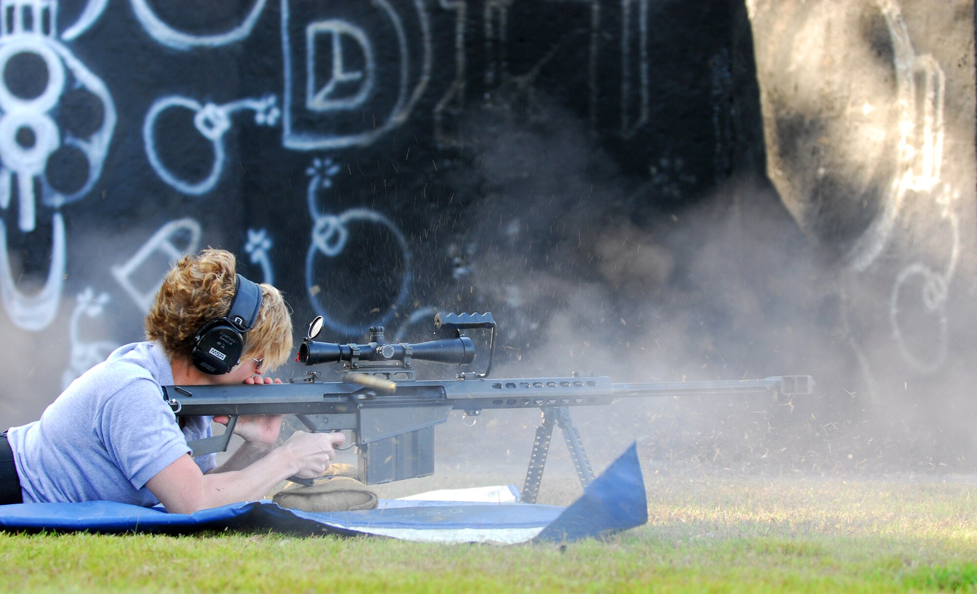 Master Sgt. Tanya Breed fires a Barrett .50-caliber rifle at a target 300 meters downrange during a weapons capabilites demonstration Jan. 9 on the Dynamics of International Terrorism range at Hurlburt Field, Fla. Sergeant Breed shows the crowd capabilites of sniper fire at various targets. The demonstration showed students the capabilities of weapons primarily used by terrorist groups. Students from all branches of the U.S. military participated in the course. Sergeant Breed is assigned to the Air Force Special Operations School. (U.S. Air Force photo/Airman 1st Class Jason Epley)
