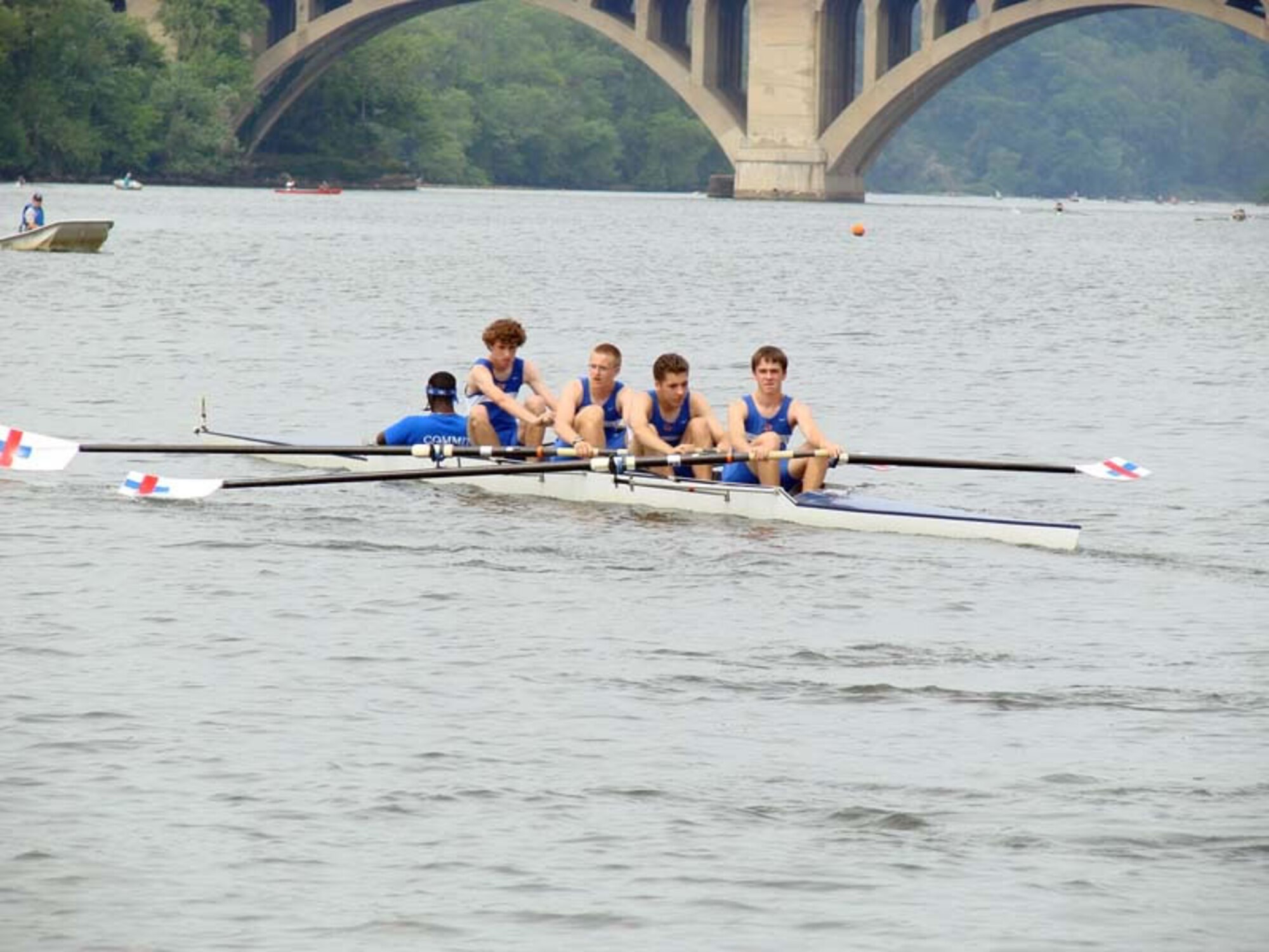 A launch boat driver is seen in the background as a crew boat is leaving the dock to row up river.  Lisa Schappacher’s son, Michael, is seated behind the coxswain of the boat. (Photo provided)