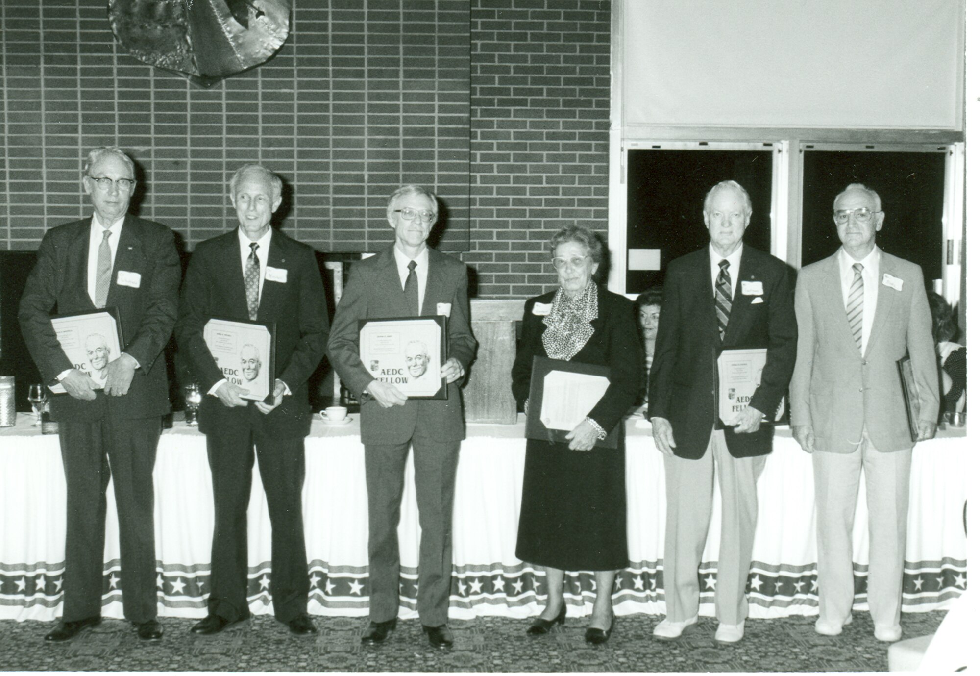 On behalf of her late husband, Mrs. Hertha Goethert accepts Dr. B.H. Goethert's AEDC Fellow plaque at the induction ceremony in 1989. (AEDC historical photo)