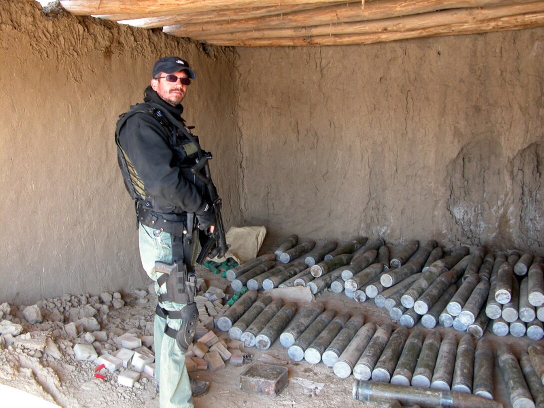 AFOSI agent with weapons cache in Afghanistan (U.S. Air Force photo)