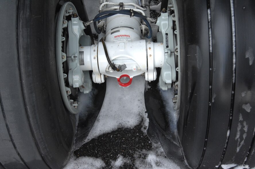A KC-135 Stratotanker from Fairchild Air Force Base, Wash., reported an in-flight emergency when two tires blew out before landing here Dec. 18. Airmen from RAF Mildenhall worked together to remove it from the runway as fast as possible, replacing three tires and performing an inspection to ensure its airworthiness. (U.S. Air Force photo/Senior Airman Teresa Hawkins)  