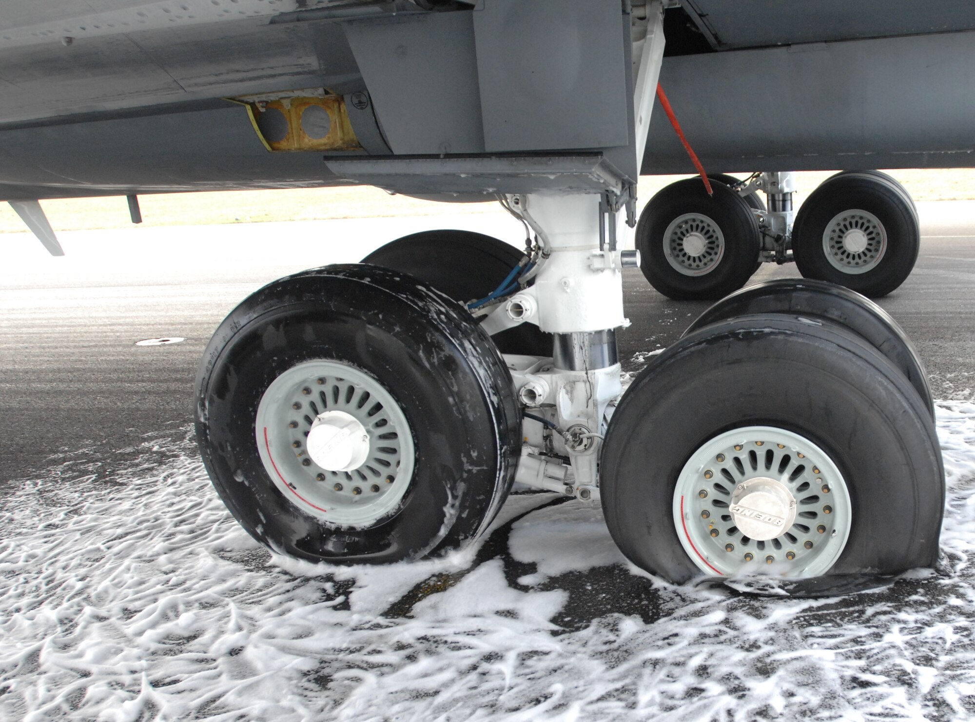 A KC-135 Stratotanker from Fairchild Air Force Base, Wash., reported an in-flight emergency when two tires blew out before landing here Dec. 18. Several agencies worked together on base to save the aircraft from further damage when the tires caught fire after landing. (U.S. Air Force photo/Senior Airman Teresa Hawkins)  