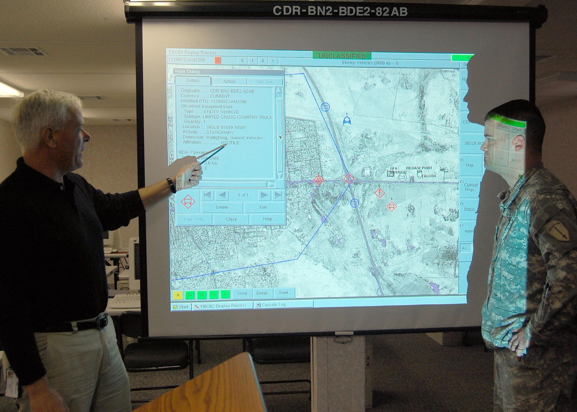 FORT BRAGG, N.C. - Retired Special Forces Master Sgt. Bo Ramsey discusses displayed data on an IED which was plotted on the Blue Force Tracker with Army Capt. Rick Eggleston who deployed from Ft. Benning, Ga. The BFT system uses the tactical internet, aided by satellite communications links when terrain features interrupt line-of-sight communication.  That constant flow of information puts leaders at all levels on the same page. (U.S. Air Force photo/Capt. Ken Hall)