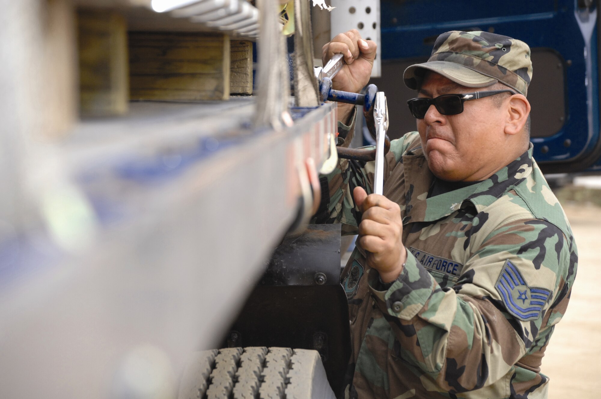 Tech. Sgt. Raul Macias, along with other 163rd Reconnaissance Wing members, tears down and packs up equipment used for the tent city  in Vista, Calif., at the North County Courthouse on November 6. The site was used for the relief efforts of the San Diego Wildfires. (U.S. Air Force photo by Staff Sergeant Diane Ducat )