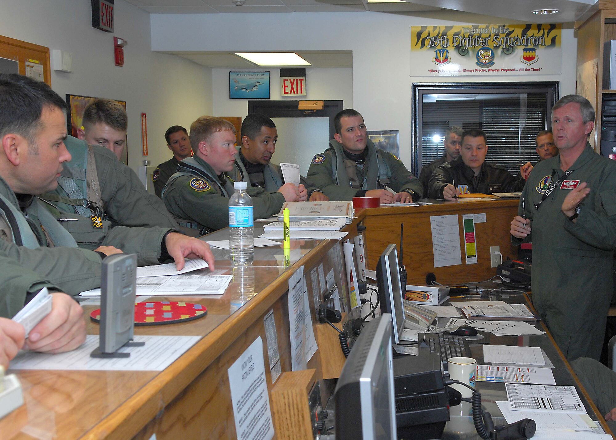 SHAW AIR FORCE BASE, S.C. -- Pilots from the 79th Fighter Squadron are briefed prior to their deployment to the Pacific Air Forces theater of operations Jan. 12. Approximately 300 Airmen and 20 F-16s from Shaw deployed for the operation. (U.S. Air Force photo/Airman 1st Class William Coleman)