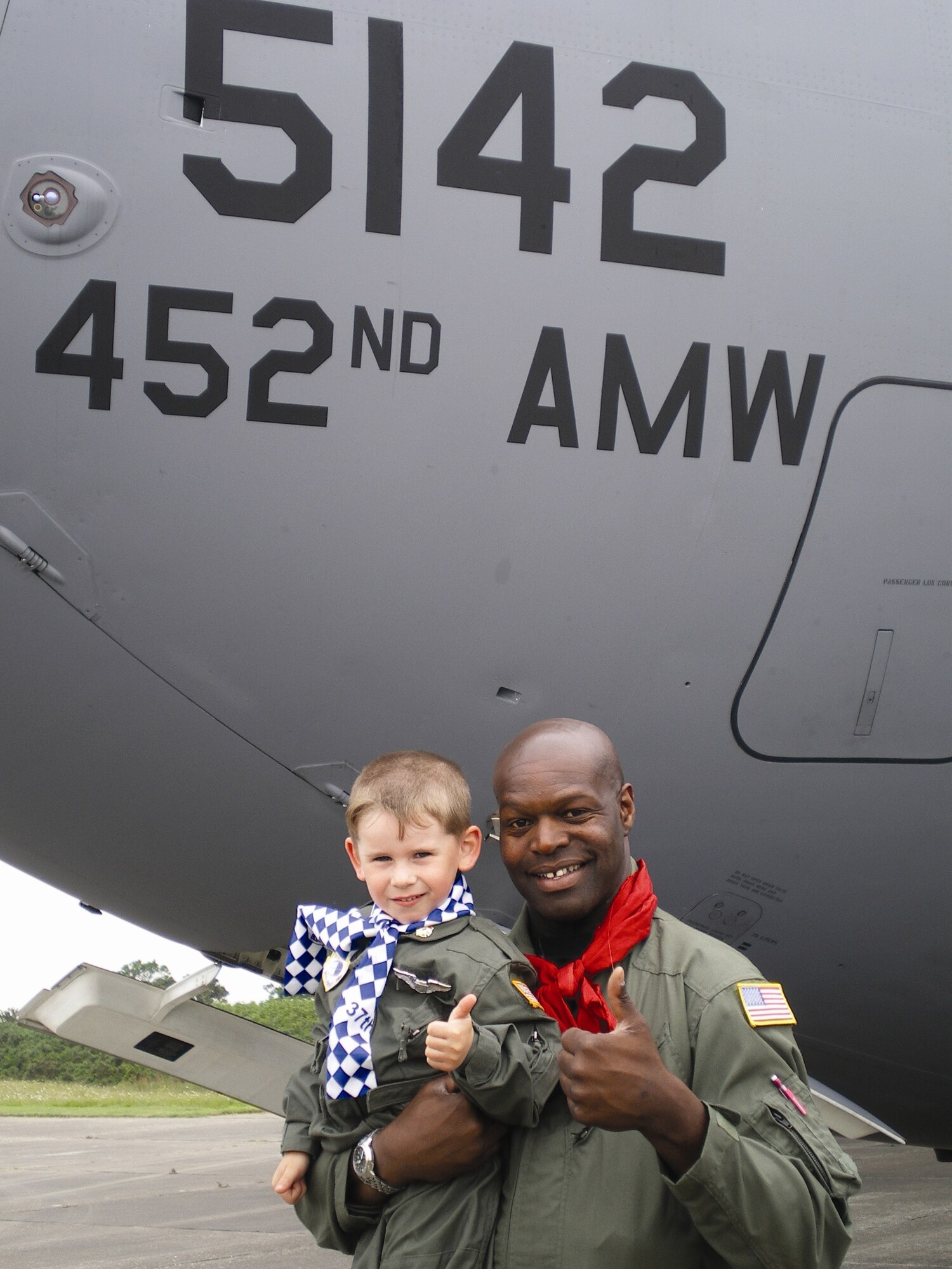 Staff Sgt. Winston Demmin, 729th Airlift Squadron Crew Chief, befriends the son
of Dennis Dennebouy, president of the Picauville Historical Society, Picauville, France, in June during a mission there. On the day of the crew’s departure, nearly the entire town came to the airport to see them off. According to other 729th troops, the young boy was “so enamored with Sergeant Winston that he begged our gentle giant to hold him for a picture.” The boy had his father make him an American flight suit for the occasion, complete with U.S. flag and wings, saying that when he grows up he “wants to be an American pilot.” (U.S. Air Force photo)