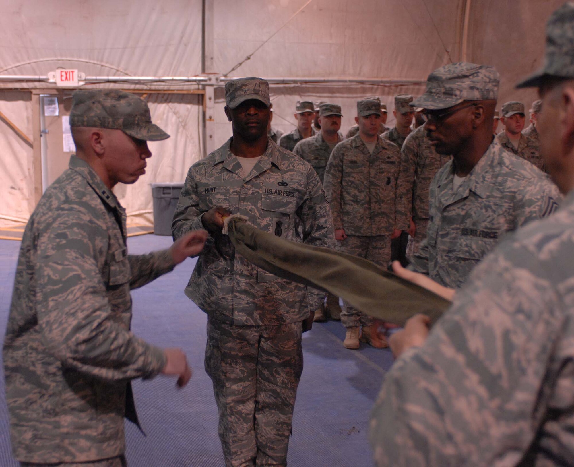 BAGRAM AIR BASE, Afghanistan – The 755th Expeditionary Security Forces Squadron guidon is cased here Jan. 11, 2008.  The squadron, originally formed in December 2005 in response to a U.S. Army request for support of its detainee operations mission, was inactivated during a formal ceremony here today. (U.S. Air Force photo by Staff Sgt. Mike Andriacco)