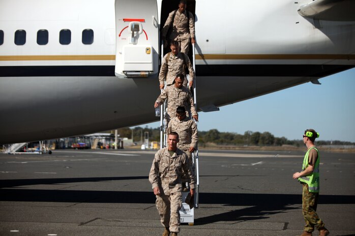 Marines and Sailors with the Weapons Company, Battalion Landing Team 2nd Battalion, 7th Marines, 31st Marine Expeditionary Unit, debark a plane, July 7. The Marines and Sailors are slated to participate in exercise Talisman Sabre 2011.  TS11 reflects the closeness of the Australian and U.S. alliance and the strength of the military-to-military relationship.
