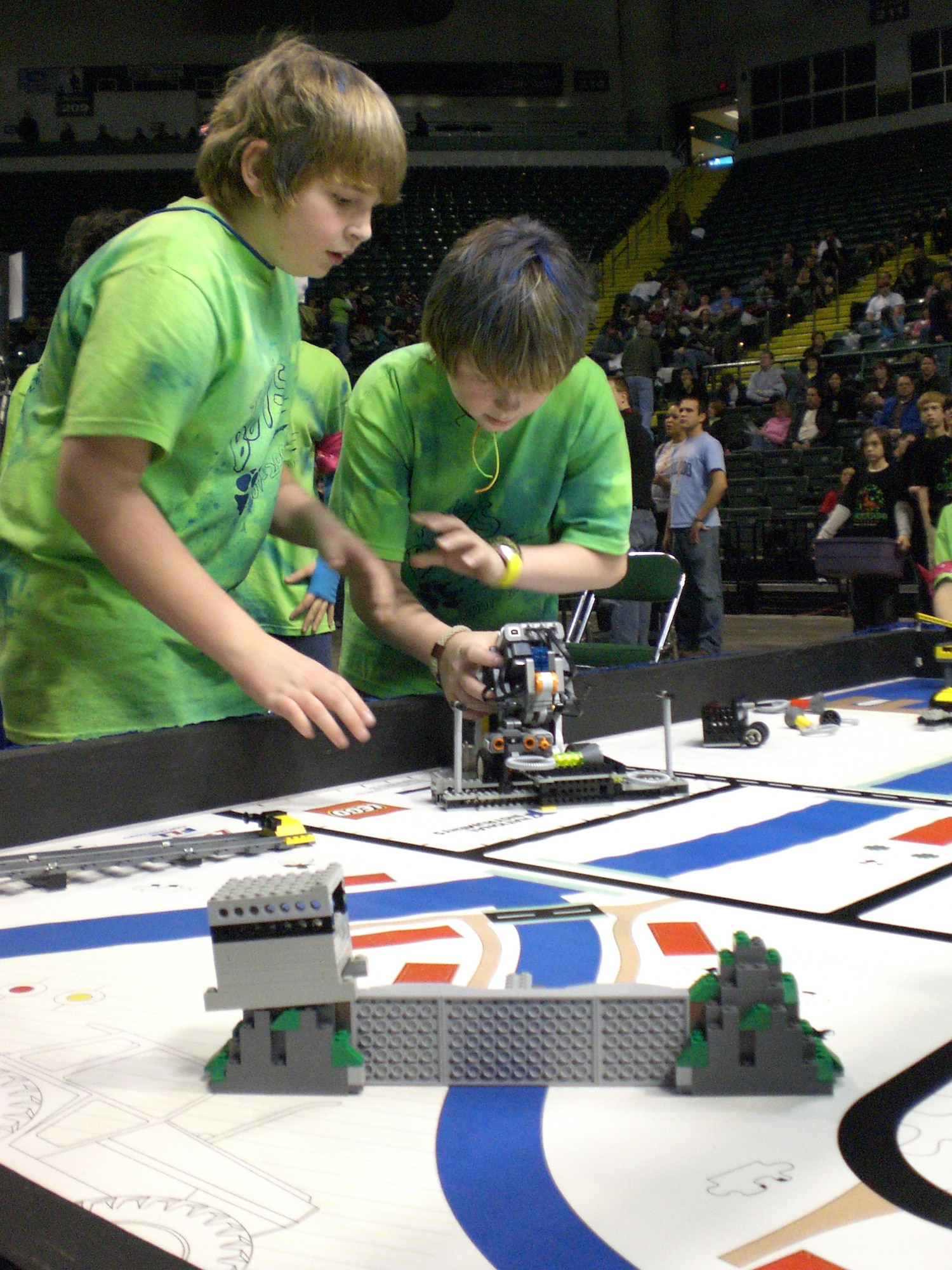 Canton sixth graders Drake Danner and Austin Blackerby quickly reposition their robot to perform a pre-programmed mission during a timed event at the FIRST LEGO League Ohio State Robotics Championship.  Wright-Patterson Air Force Base Educational Outreach Office co-sponsored the annual event which brought together 48 teams of students and mentors from across the state to demonstrate their problem solving skills and knowledge of environmental issues.  The competition was held Jan. 12-13 at Wright State University.  (U.S. Air Force photo/Derek Kaufman)
