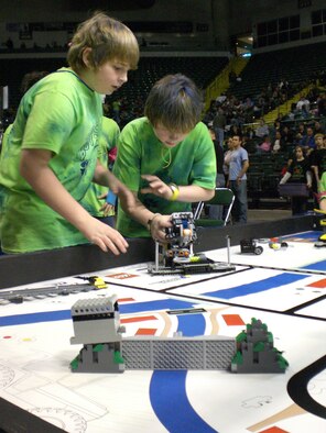 Canton sixth graders Drake Danner and Austin Blackerby quickly reposition their robot to perform a pre-programmed mission during a timed event at the FIRST LEGO League Ohio State Robotics Championship.  Wright-Patterson Air Force Base Educational Outreach Office co-sponsored the annual event which brought together 48 teams of students and mentors from across the state to demonstrate their problem solving skills and knowledge of environmental issues.  The competition was held Jan. 12-13 at Wright State University.  (U.S. Air Force photo/Derek Kaufman)
