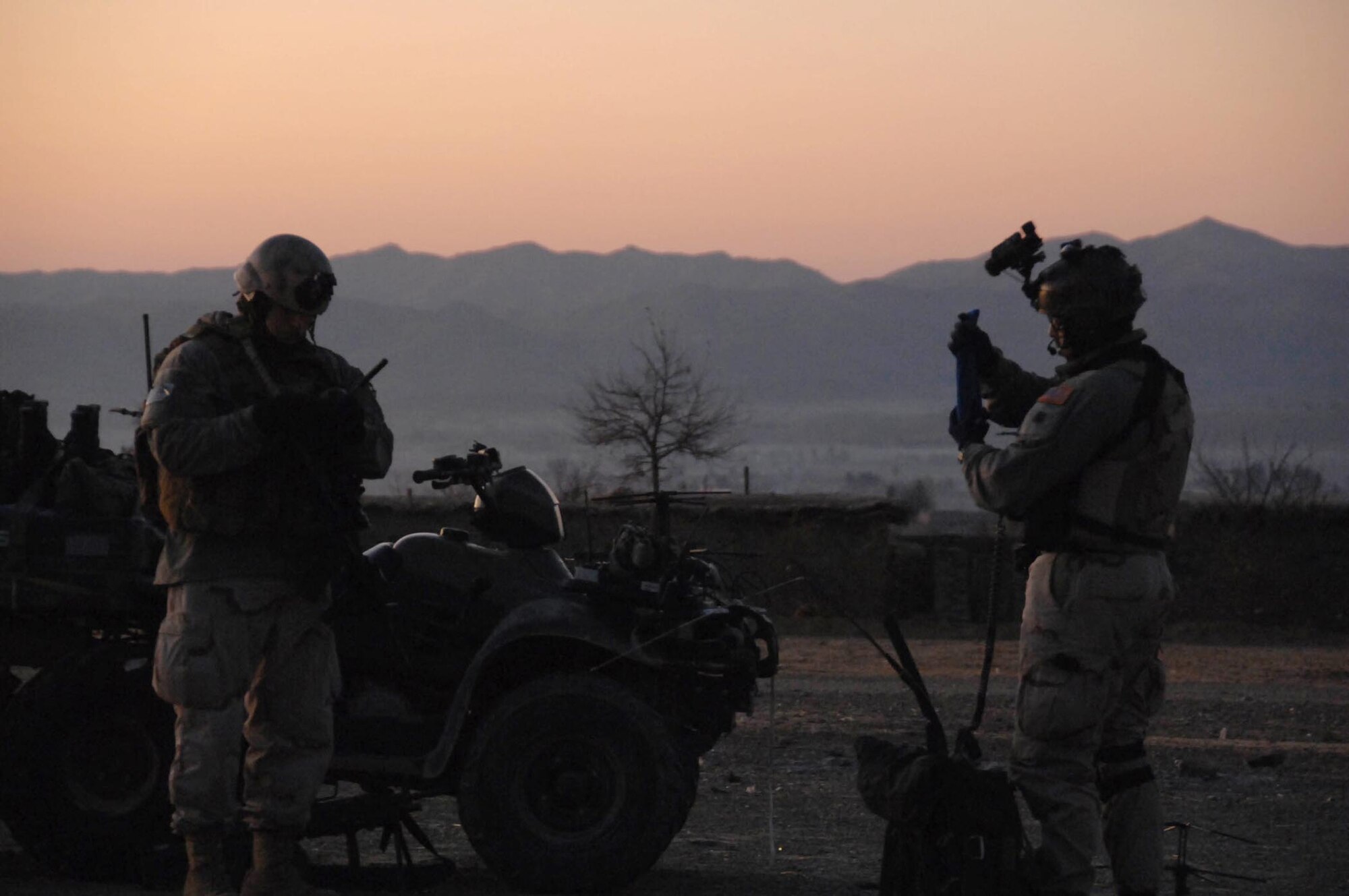 BAGRAM AIR BASE, Afghanistan - A Joint Tactical Air Controller (left) prepares to coordinate with aircraft to support troops on the ground.  JTACS are the liaison between the ground troops and the aircraft above that provide close air support. (Combined Joint Special Operations Task Force-Afghanistan photo by U.S. Army Staff Sgt. Corey Dennis)