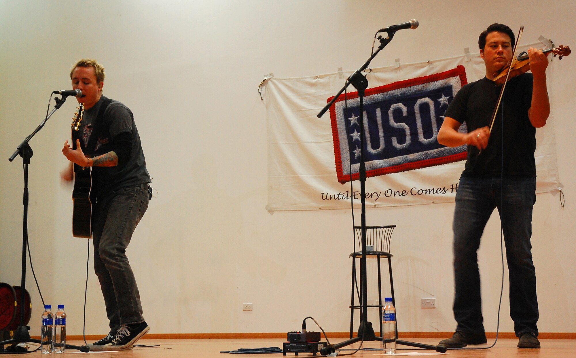SOUTHWEST ASIA -- Ryan Key, vocalist and guitar player, and Sean Mackin, violin and vocalist, for the 'Yellowcard' band performs one of their songs at an air base in the Persian Gulf region Jan. 12, 2008, as part of a five-day United Service Organizations' tour throughout the deployed theater. (U.S. Air Force photo/Senior Airman Patrick Dixon) (Released)