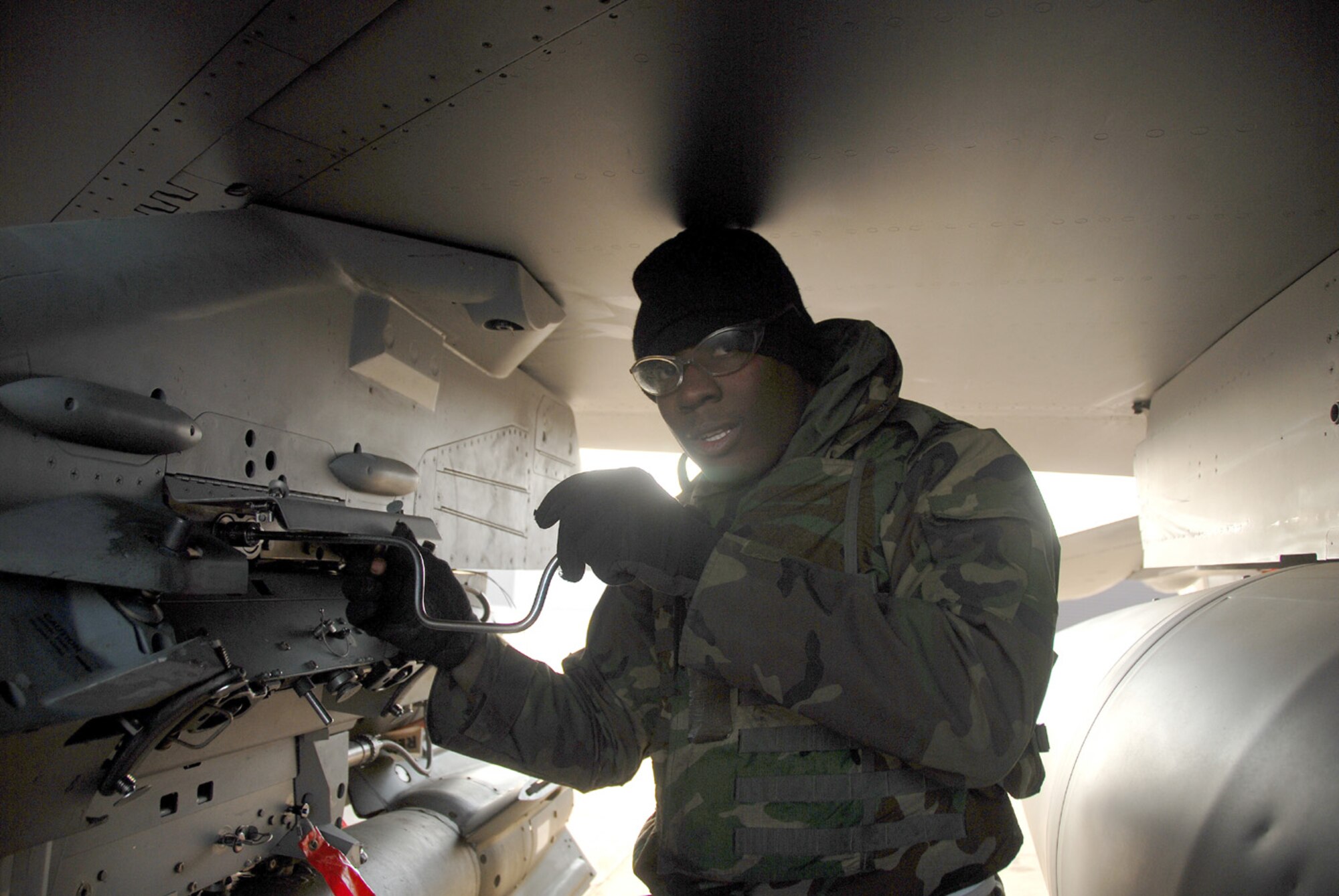 OSAN AIR BASE, Republic of Korea -- Senior Airman Christopher Sims, 51st Aircraft Maintenance Squadron, performs maintenance on an F-16 Fighting Falcon during a peninsula-wide exercise.  The operational readiness exercise tests Team Osan's ability to execute combat operations, receive follow-on forces and defend the base from attack.  (U.S. Air Force photo by Senior Airman Chad Strohmeyer)