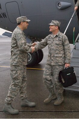 Col. Jerry Martinez, 62nd Airlift Wing commander, greets Brig. Gen. Donald Lustig, AMC Inspector General, on the flightline as he steps off a C-17. The IG team arrived Tuesday to conduct a week-long Unit Compliance Inspection of McChord. (Photo by Abner Guzman)