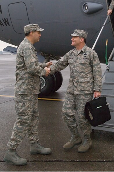 Col. Jerry Martinez, 62nd Airlift Wing commander, greets Brig. Gen. Donald Lustig, AMC Inspector General, on the flightline as he steps off a C-17. The IG team arrived Tuesday to conduct a week-long Unit Compliance Inspection of McChord. (Photo by Abner Guzman)