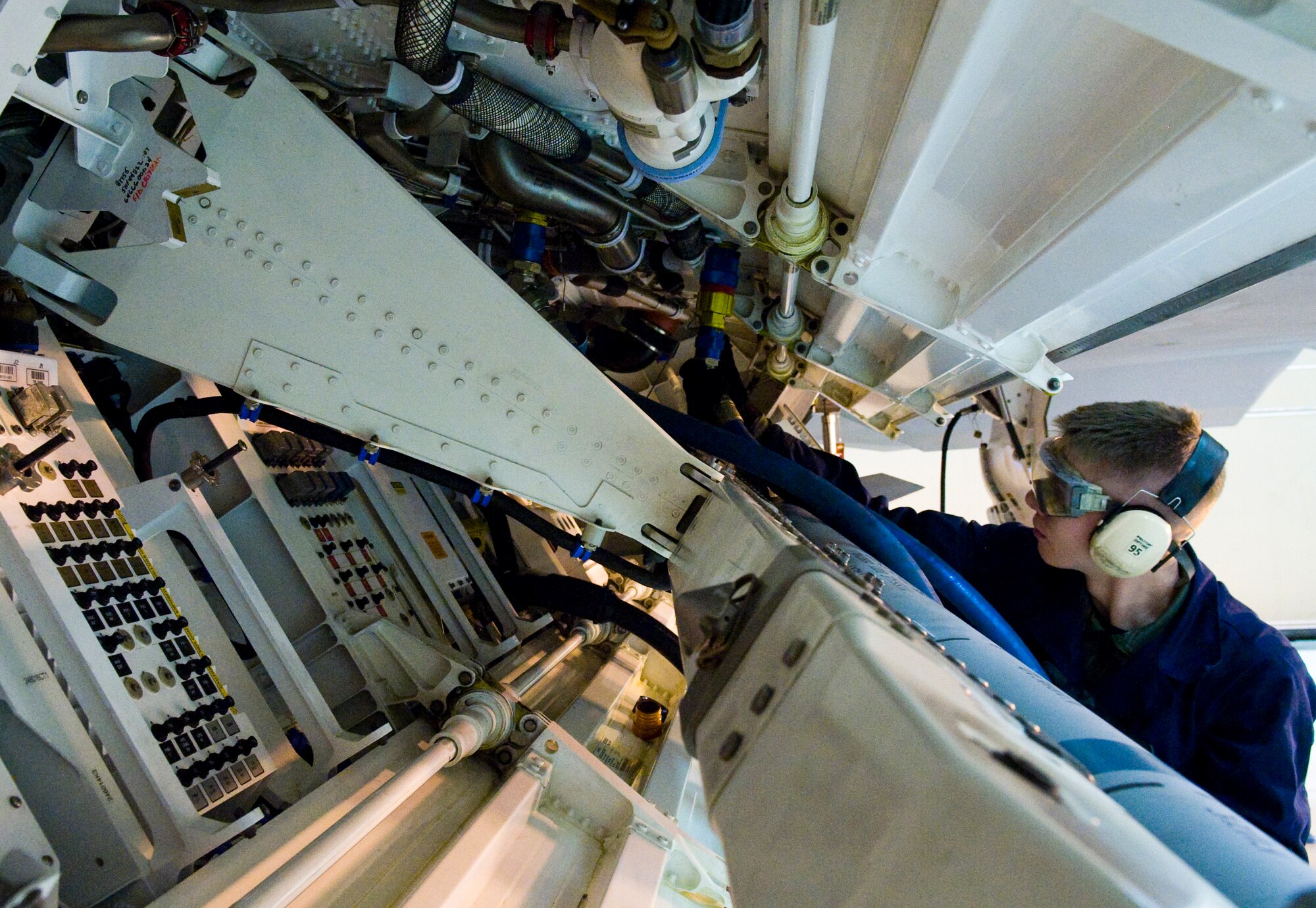 ELMENDORF AIR FORCE BASE, Alaska - Staff Sgt. Temujin Ching, 477th Aircraft Maintenance Squadron, hooks up the aft closed loop liquid cooling system to an F-22A Raptor. Polyalphaolefin (PAO) is the medium used in the liquid cooling system. The 477th AMXS is the first Reserve F-22 squadron in the Air Force. (U.S. Air Force photo/Senior Airman Garrett Hothan)