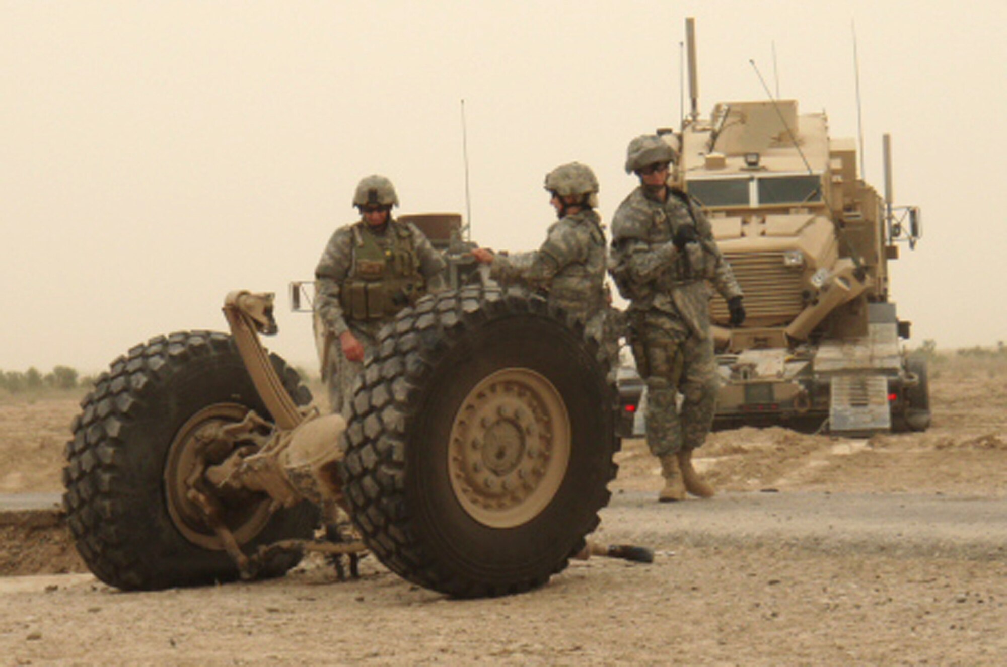 Staff Sgt. Mesa Anderson, an explosives ordnance technician, performs a post investigation and recovery mission on a coalition vehicle after it was destroyed by an improved explosive device during summer 2007 in Iraq. Actions performed by EOD flights in both Iraq and Afghanistan helped to secure the 21st Civil Engineer Squadron’s selection as the best small CE squadron in the Air Force for 2007. (Courtesy photo) 