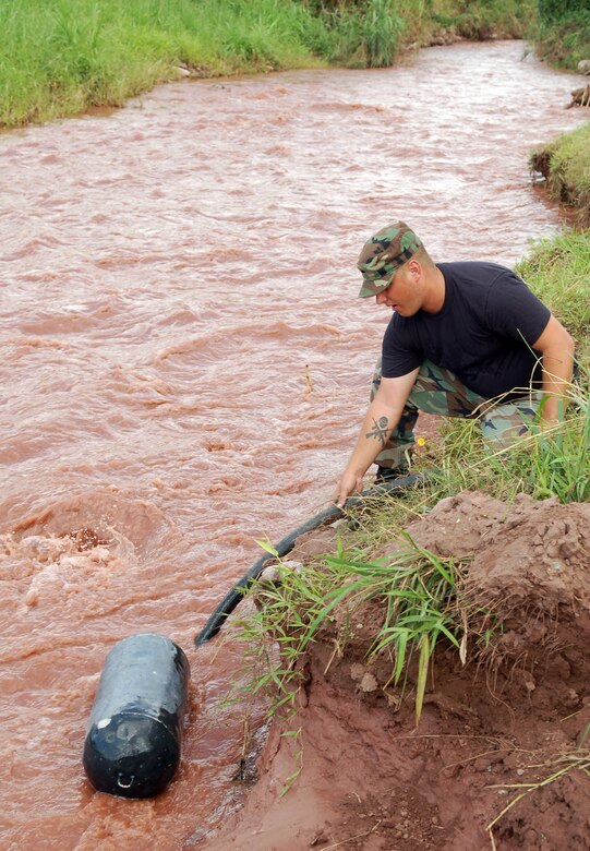 SOTO CANO AIR BASE, Honduras – Airman 1st Class Phillip Ryder, Joint Task Force-Bravo Search and Rescue team, extracts water from a creek near the base perimeter here.  SAR team members receive training on several tasks outside their normal duties at their home station.  (U.S. Air Force photo by Staff Sgt. Austin M. May)