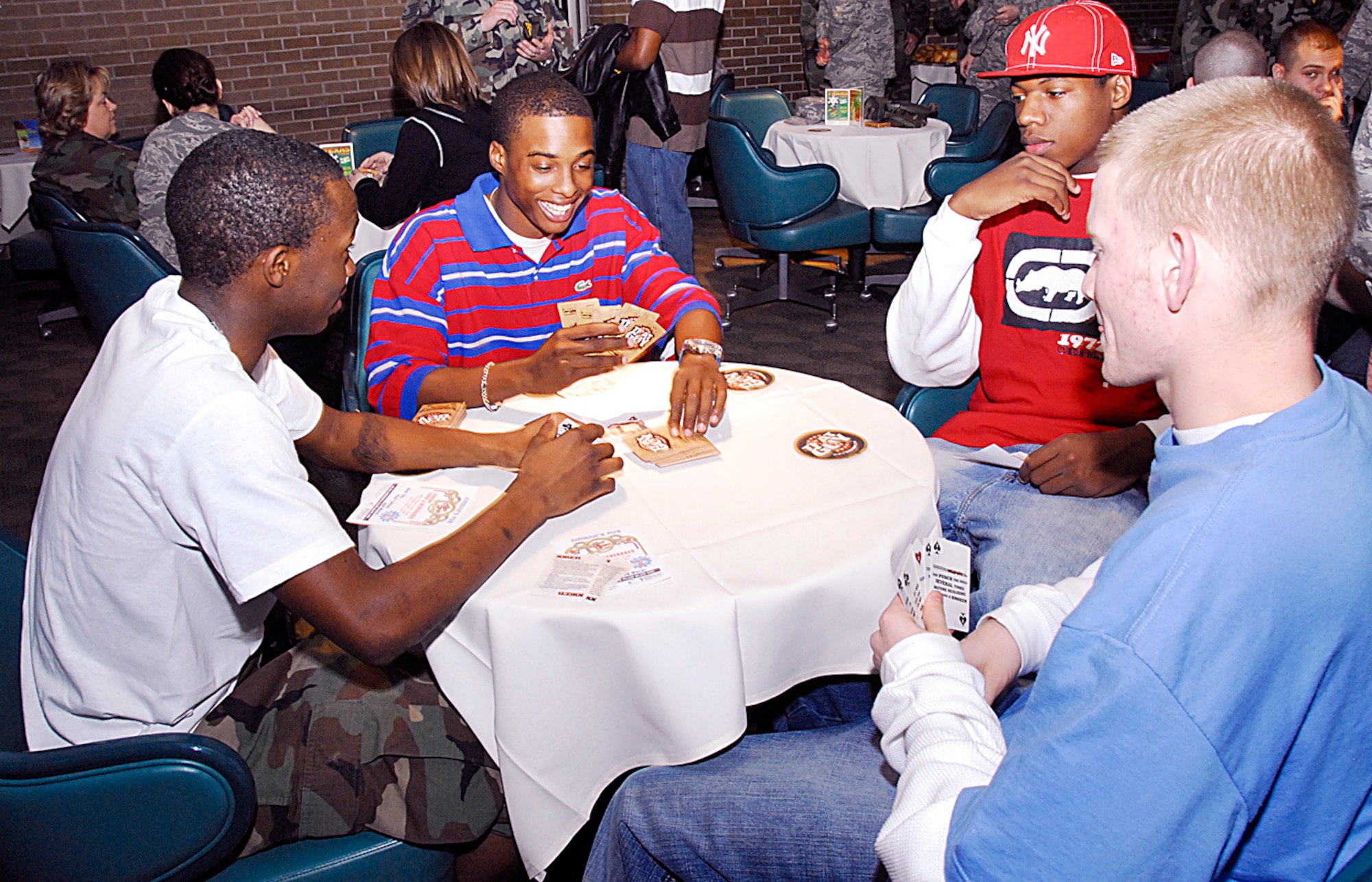 Airman Karan Blackwell, an Airman in Training with the 383rd Training Squadron, Airman Leon Jackson, an AiT with the 382nd TRS, Airman 1st Class Terry Holloway, an AiT with the 383rd TRS, and Airman 1st Class Johnathon King, an AiT with the 382nd TRS, play cards prior to the opening ceremony of the Airman's Pub Jan. 11. The Airman's Pub is more than just a bar and recreational area, the $70,000 renovated pub offers the same fun and camaraderie without the outside influences of downtown establishments. (U.S. Air Force photo/Harry Tonemah)