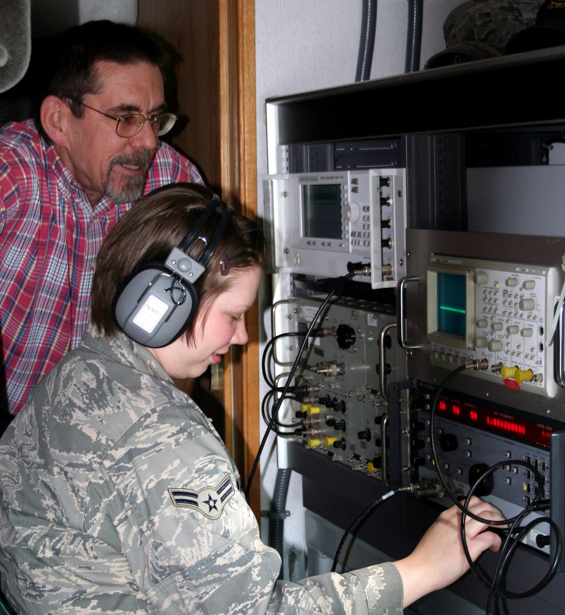 Barry Booth leads Airman 1st Class Michelle Wallen through the measurement and recording of a signal of interest during a recent emission security test of a laptop computer intended for use in a classified system.  Mr. Booth and Airman Wallen are assigned to the 346th Test Squadron's Emission Security Flight.  (U.S. Air Force photo/Airman 1st Class Sidney Sparks)