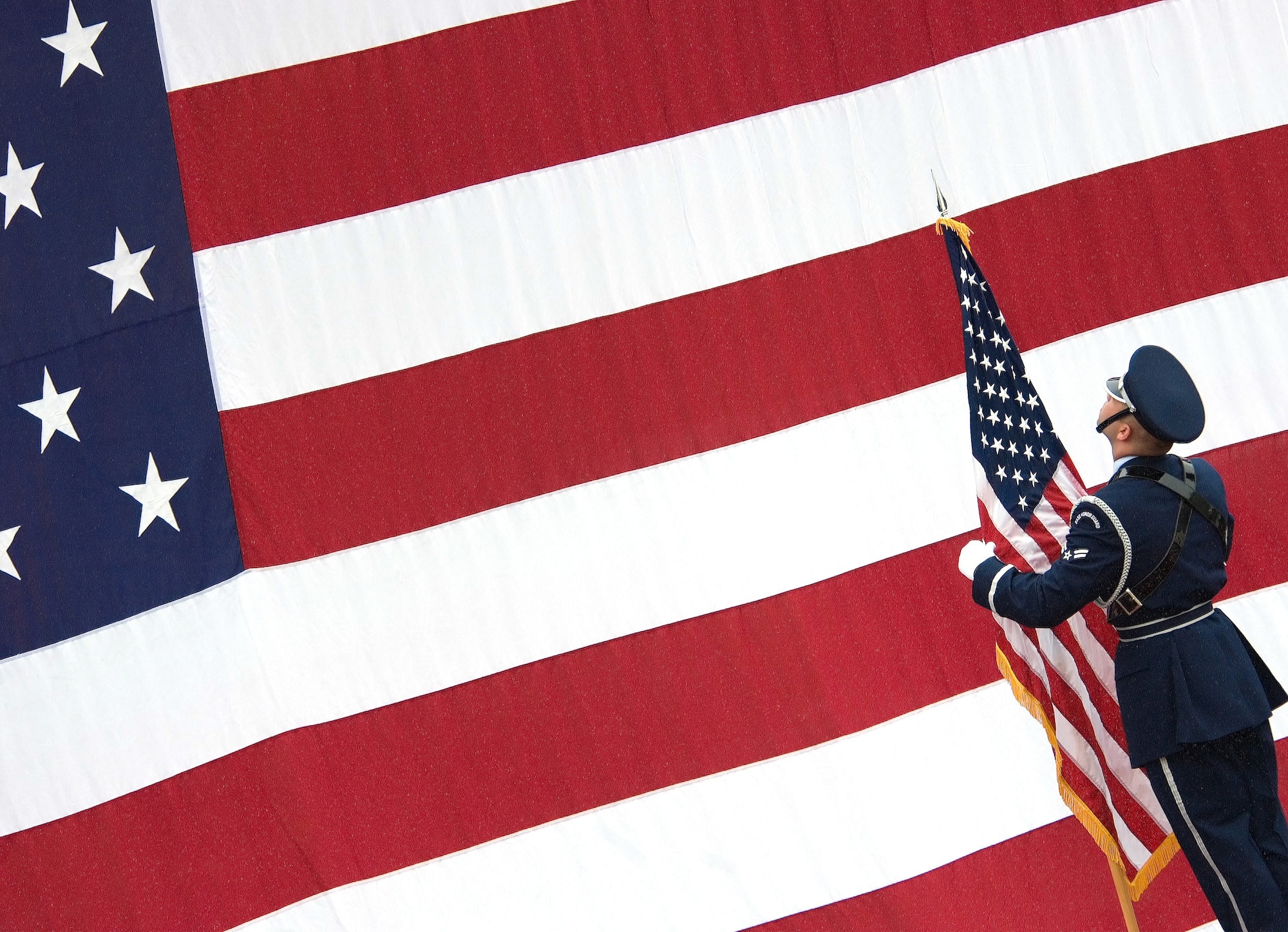 An Airman pays proper respect to the flag. In the article featured here, Chief Master Sgt. Timothy Omdal, 21st Space Wing command chief, identifies the proper ways to render respect to the American flag at different times of day. (U.S. Air Force photo)