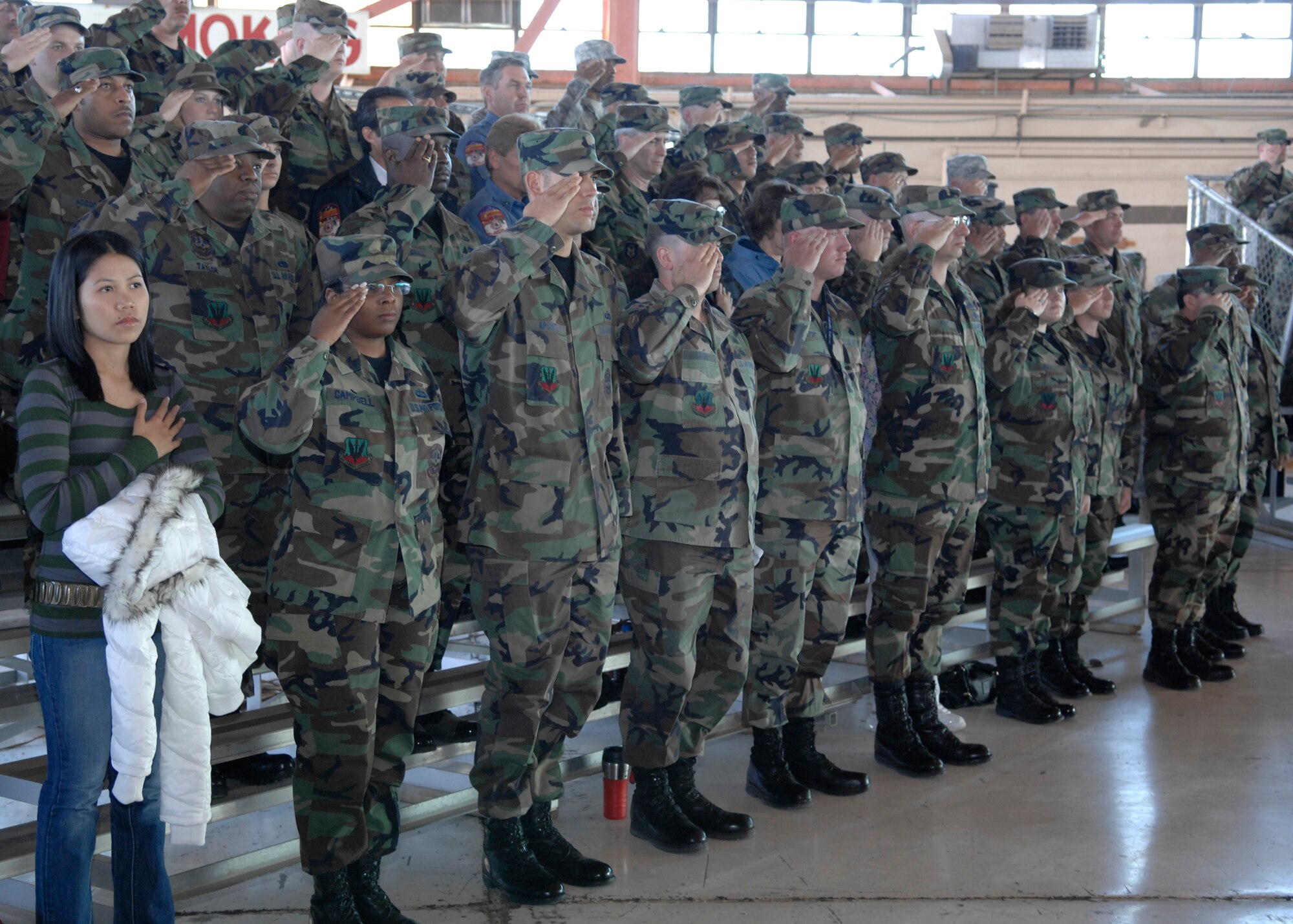 Airmen salute during the playing of the National Athem at the 49th Fighter Wing change of command ceremony, Holloman Air Force Base, N.M. on Jan. 11, 2008. Col. Jeffrey Harrigian assumed command for Brig. Gen. David Goldfein. (U.S. Air Force photo/Airman 1st Class Rachel A. Kocin)