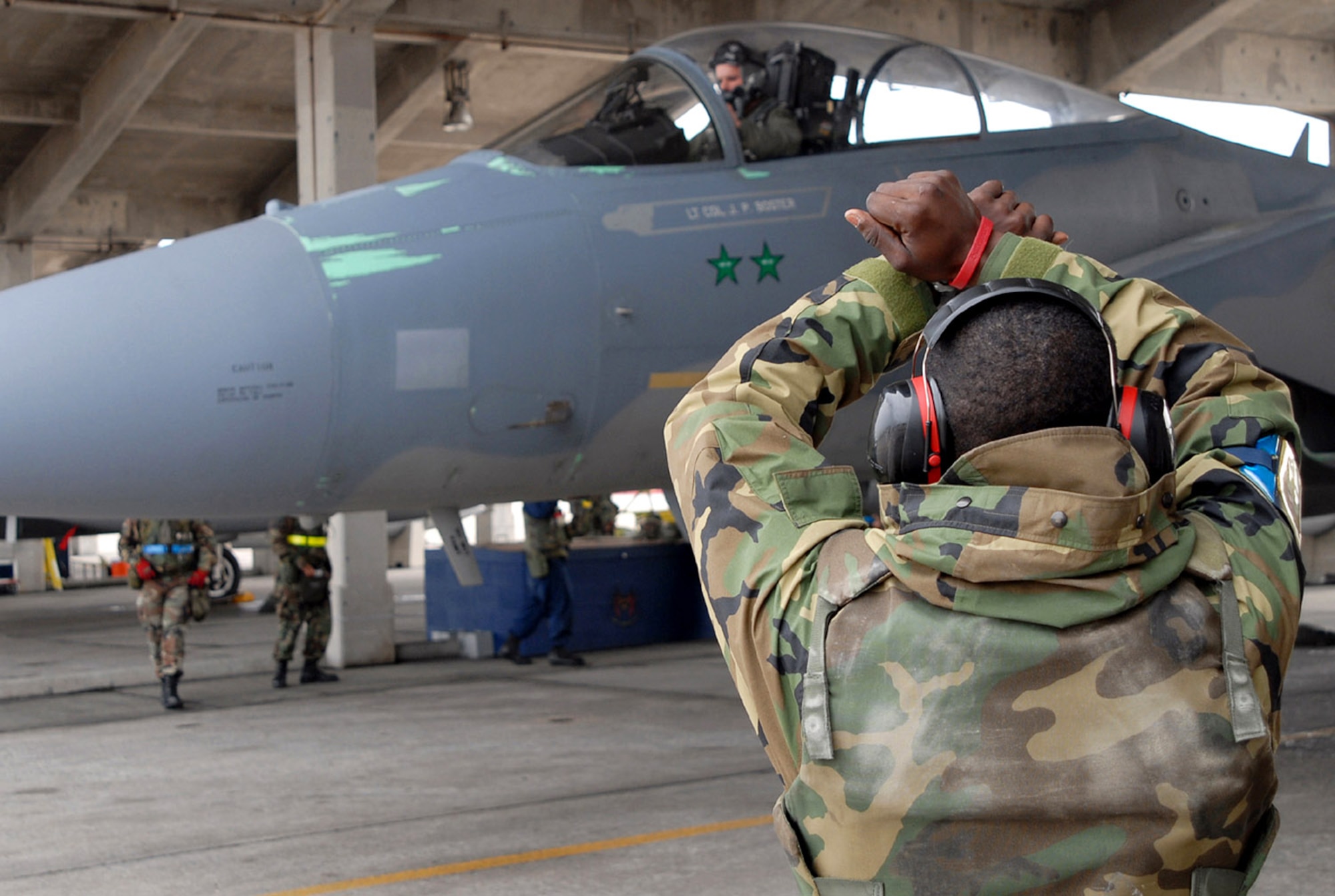 Airman 1st Class Lewis McNeal marshals an F-15 Eagle piloted by Capt. Mike Jones during Exercise Beverly High 08-3 Jan. 9 at Kadena Air Base, Japan. Kadena AB F-15s were grounded since November, but 65 percent of the fleet was cleared to resume flight operations. Airman McNeal is assigned to the 18th Aircraft Maintenance Squadron, and Captain Jones is from the 44th Fighter Squadron. (U.S. Air Force photo/Tech. Sgt. Dave DeRemer) 
