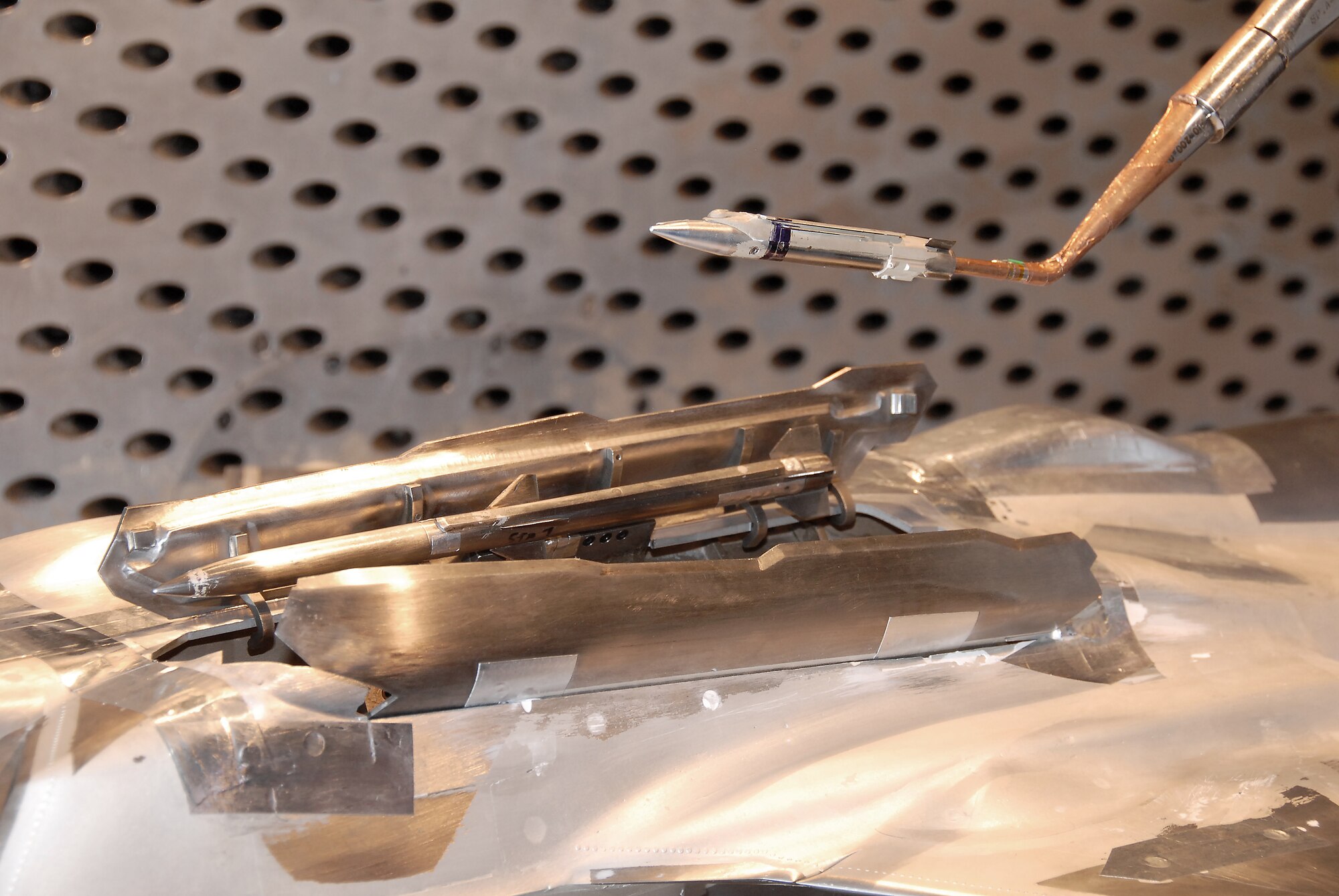 A model of a GBU-39 Small Diameter Bomb (SDB) mounted on a sting is separated from the F-35 Lightning II aircraft during a test in Arnold Engineering Development Center’s (AEDC) four-foot transonic wind tunnel.  (Photos by Rick Goodfriend)