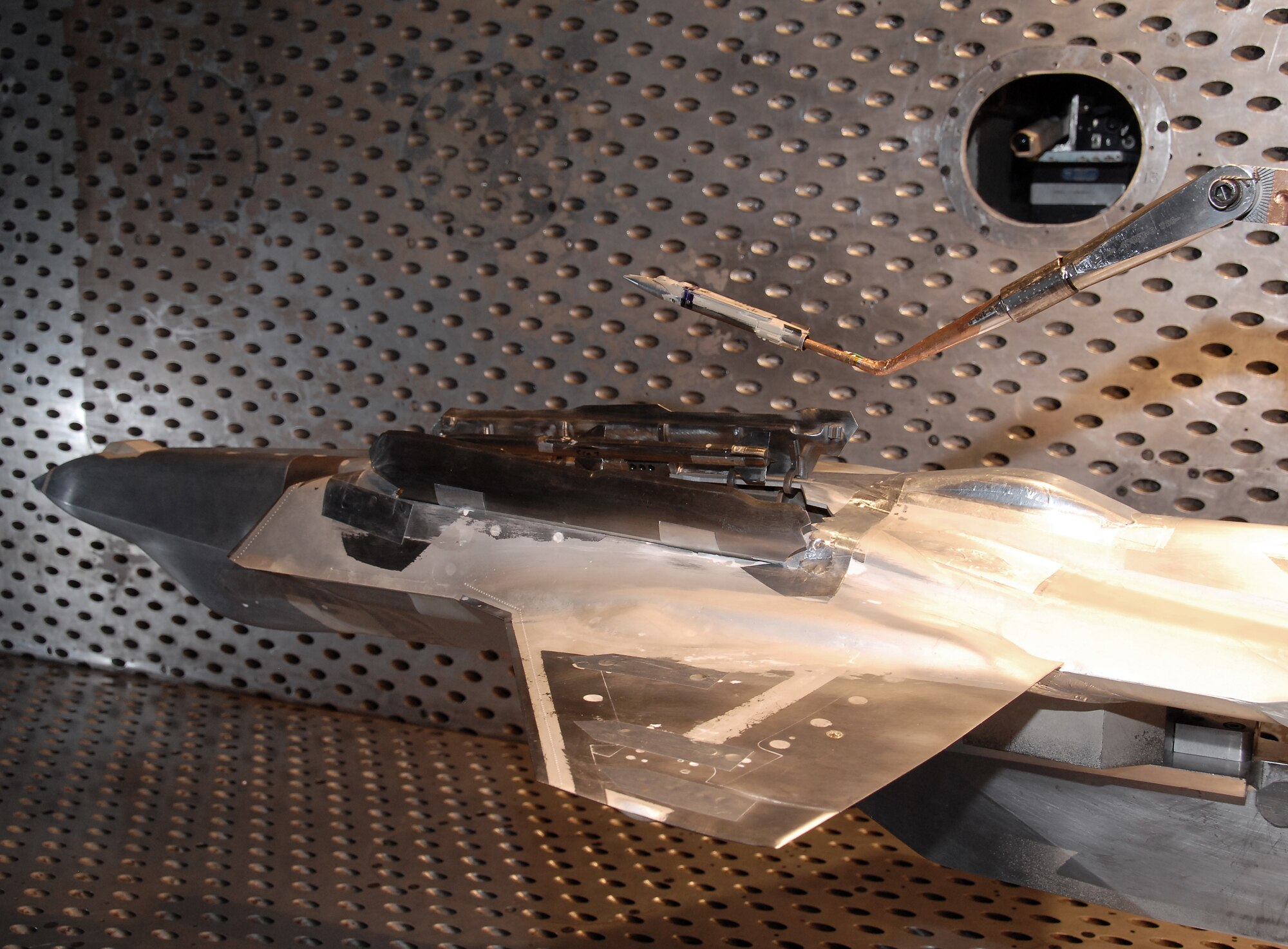 A model of a GBU-39 Small Diameter Bomb (SDB) mounted on a sting is separated from the F-35 Lightning II aircraft during a test in Arnold Engineering Development Center’s (AEDC) four-foot transonic wind tunnel.  (Photos by Rick Goodfriend)