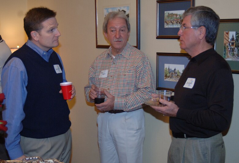 Colonel Jeff Dunn, 14th Flying Training Wing vice commander, Bob Taylor, 14th Security Forces Squadron honorary commander, and Leon Ellis, 14th Mission Support Group honorary commander, talk over drinks Saturday during the New Year’s reception at Col. Dave Gerber’s home.  (U.S. Air Force photo by Airman 1st Class Danielle Hill)
