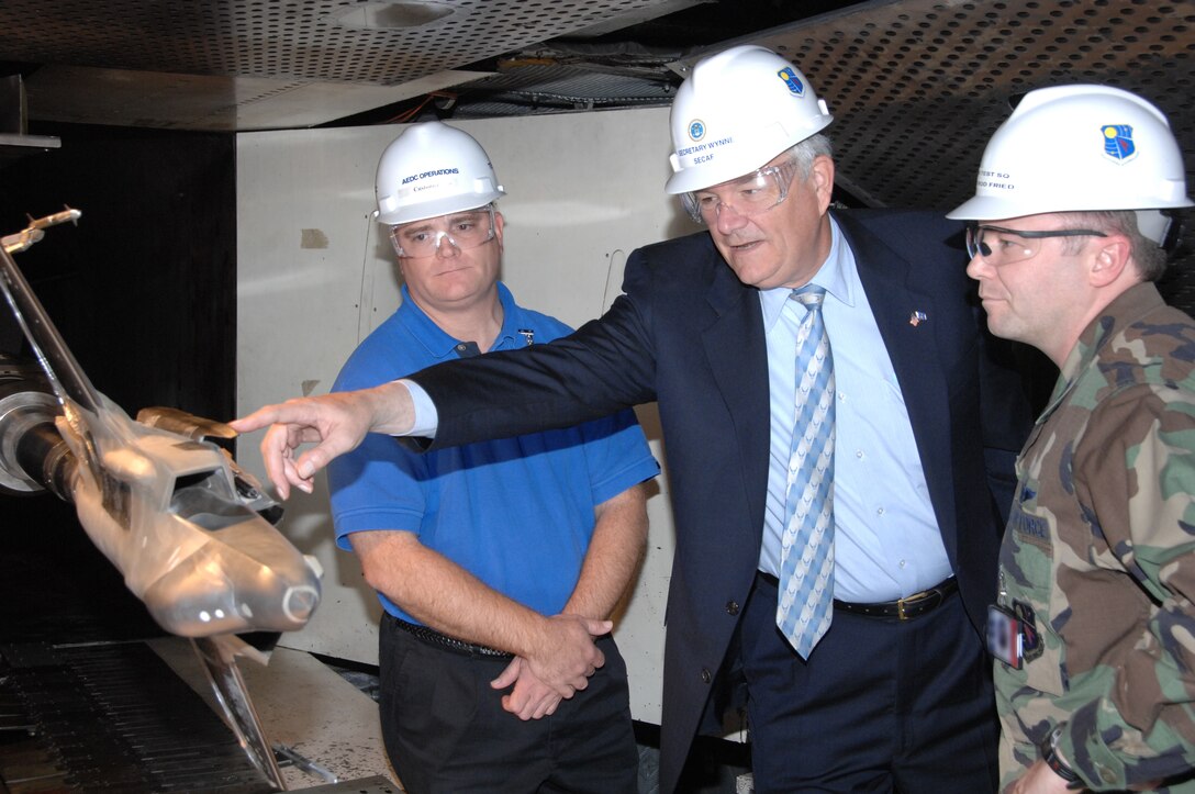 Secretary of the Air Force Michael W. Wynne asks questions about the models being used to conduct F-35 Lightning II store separation testing in the Arnold Engineering Development Center’s (AEDC) four-foot transonic wind tunnel. Capt. Rod Fried, Air Force flight systems test manager with AEDC’s 716th Test Squadron, and F-35 Store Separation Engineer Chris Hetreed with Lockheed Martin, were on hand to answer questions during Secretary Wynne’s first visit to the center Nov. 27, 2007. (Photo by David Housch)