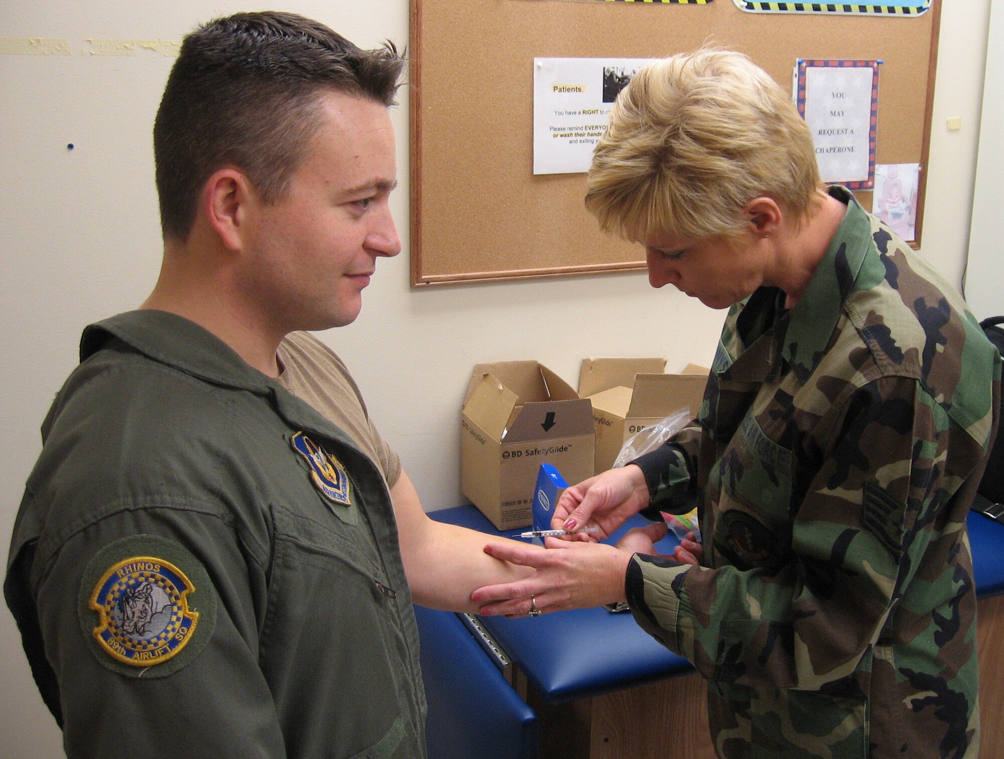 WRIGHT-PATTERSON AFB, Ohio - Master Sgt. Larry Unger, a loadmaster with the 89th Airlift Squadron, receives the tuberculosis skin test during his annual physical from Staff Sgt. Belinda Tennyson, 445th Aerospace Medicine Squadron, at the base clinic January 12, 2008.  Physicals are conducted by AMDS once a month to keep 445th members worldwide qualified.  (U.S. Air Force photo/Tech. Sgt. Charlie Miller)
