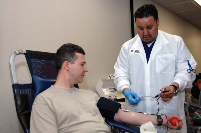 Jesse Nunez, United Blood Services phlebotomist, draws blood from Maj. Christopher Barack, 57th Maintenance Operation Squadron commander, during the 57th Wing sponsored blood drive held here, Jan. 11. Throughout 2007, Nellis and Creech personnel donated more than 1,100 units of blood spanning more than 30 separate blood drives. (U.S. Air Force photo by Staff Sgt. Scottie McCord) 