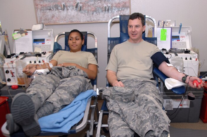 Airman 1st Class Ballina Bush, 57th Component Maintenance Squadron, and Maj. Christopher Barack, 57th Maintenance Operation Squadron commander, give blood to the Haemonetics MCS+, which collects two units of red blood cells from each volunteer during the 57th Wing sponsored blood drive held here Jan. 11.   Throughout 2007, Nellis and Creech personnel donated more than 1,100 units of blood  spanning more than 30 separate blood drives. (U.S. Air Force photo by Staff Sgt. Scottie McCord)