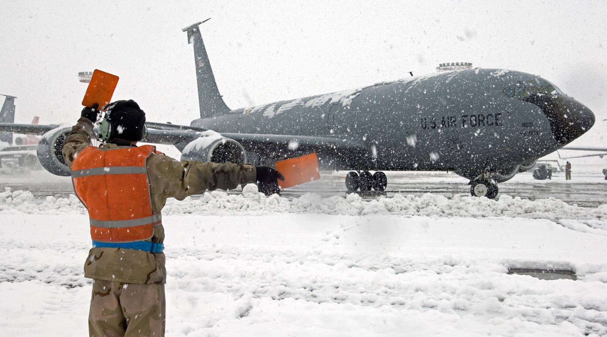 Staff Sgt. Manuel Garibay, 376th Air Expeditionary Maintenance Squadron crew chief, directs a KC-135 to the runway.  (U.S. Air Force photo by James Westfall)
