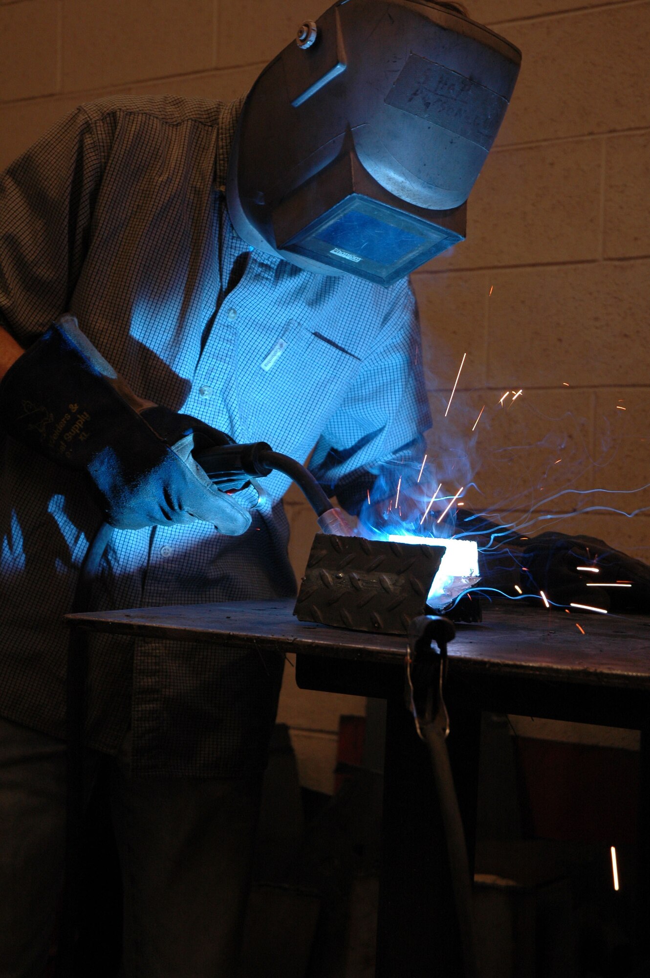 Dave Dower, from the 341st Civil Engineer Squadron, practices his MIG welding technique at the base arts and crafts center Jan. 10. Mr. Dower takes classes at the auto-hobby shop to practice skills he will later use to restore his Corvette. The next welding class will cover MIG welding and plasma cutting and costs $25. Class times are scheduled based on the amount of students signed up to take a class. (U.S. Air Force photo/Airman 1st Class Dillon White)