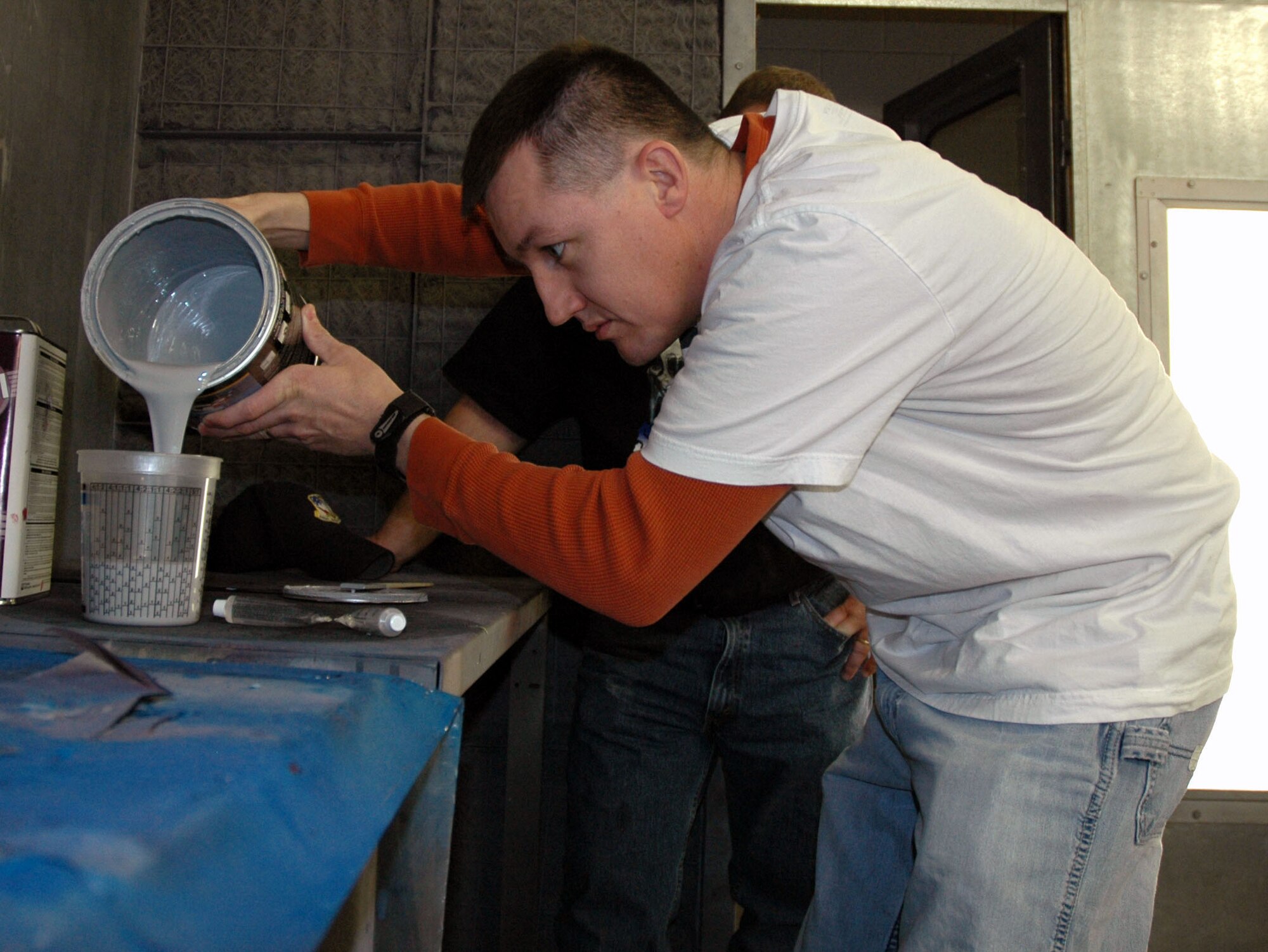 1st Lt. Daniel Castle, 564th Missile Squadron deputy flight commander, pours primer into a mixing cup during an automotive paint and body-work class at the base arts and crafts center Jan. 10. The paint and body-work class costs $100 including materials. Classes are scheduled when there are enough students to hold a class. An introductory automotive paint class is scheduled for Jan. 23 from 5:30 p.m. to 9 p.m. Students are required to sign up a week in advance and the class costs $25 including materials. Students learn how to use the paint booth and paint gun and will receive certification to use them. (U.S. Air Force photo/Airman 1st Class Dillon White)