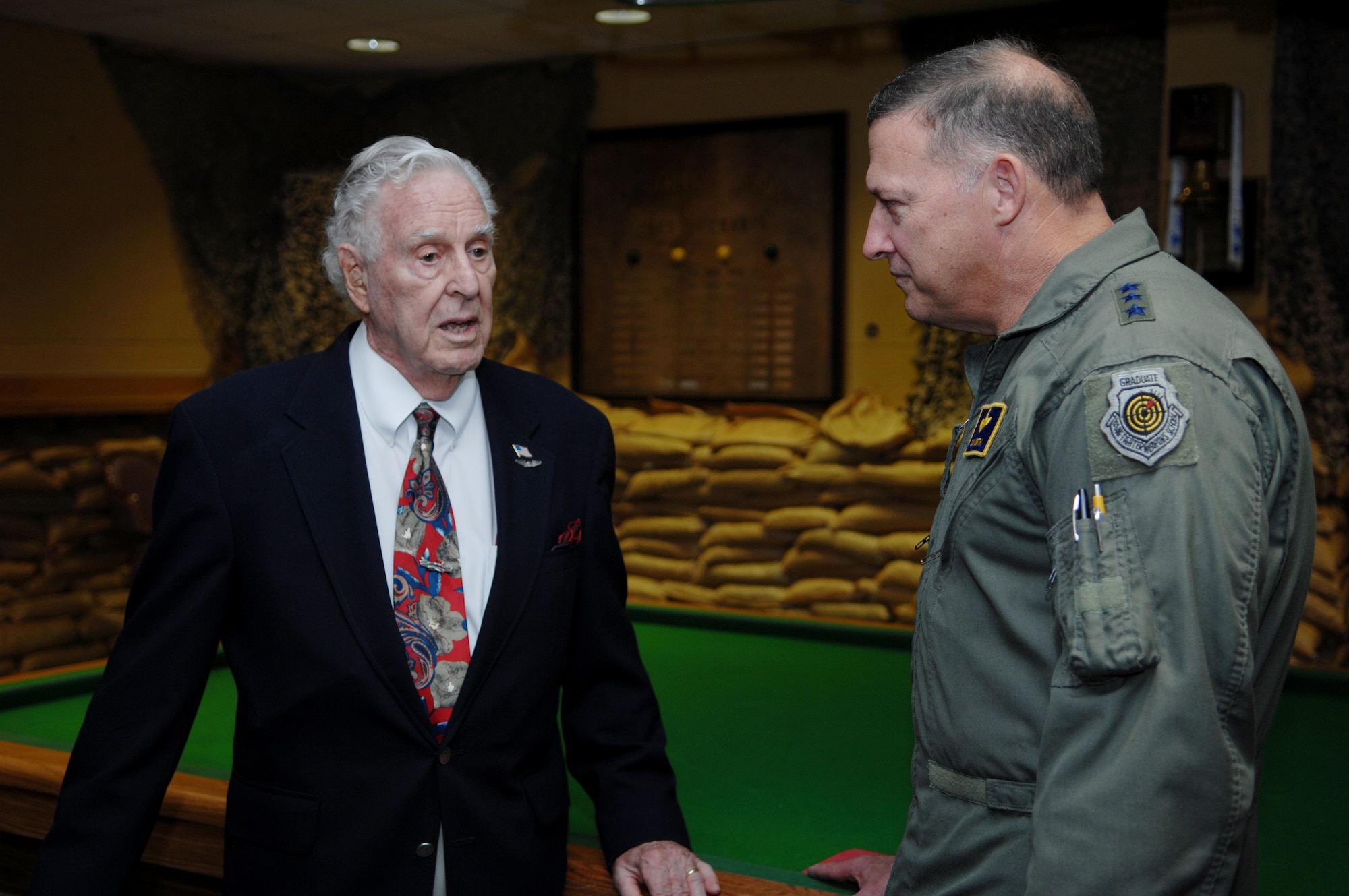 MOODY AIR FORCE BASE, Ga. – Lt Gen. Gary North, 9th Air Force Commander, speaks with Retired Capt. Henry Baker, World War II veteran, before the presentation of the Air Force Distinguish Flying Cross Medal Jan 7.  Captain Baker was sharing some of his experiences with General North before the ceremony.(U.S. Air Force photo by Senior Airman Angelita Lawrence)