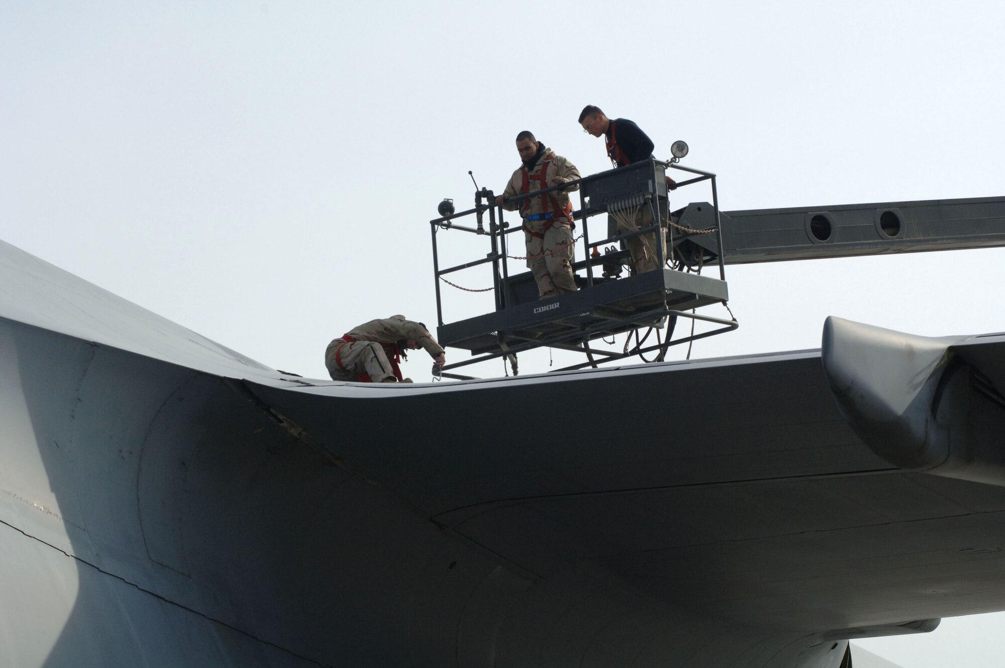 Members of the 721st Air Mobility Operations Group Det. 5 perform maintenance on a C-5 Galaxy Jan. 12 at Balad Air Base, Iraq. The 721st AMOG provides en route maintenance and support for the Air Force's C-5 and C-17 Globemaster III aircraft. The C-5 is one of the largest aircraft in the world, and the largest airlifter in the Air Force inventory. The Airmen are deployed from Travis Air Force Base, Calif. (U.S. Air Force photo/Senior Airman Terri Barriere) 
