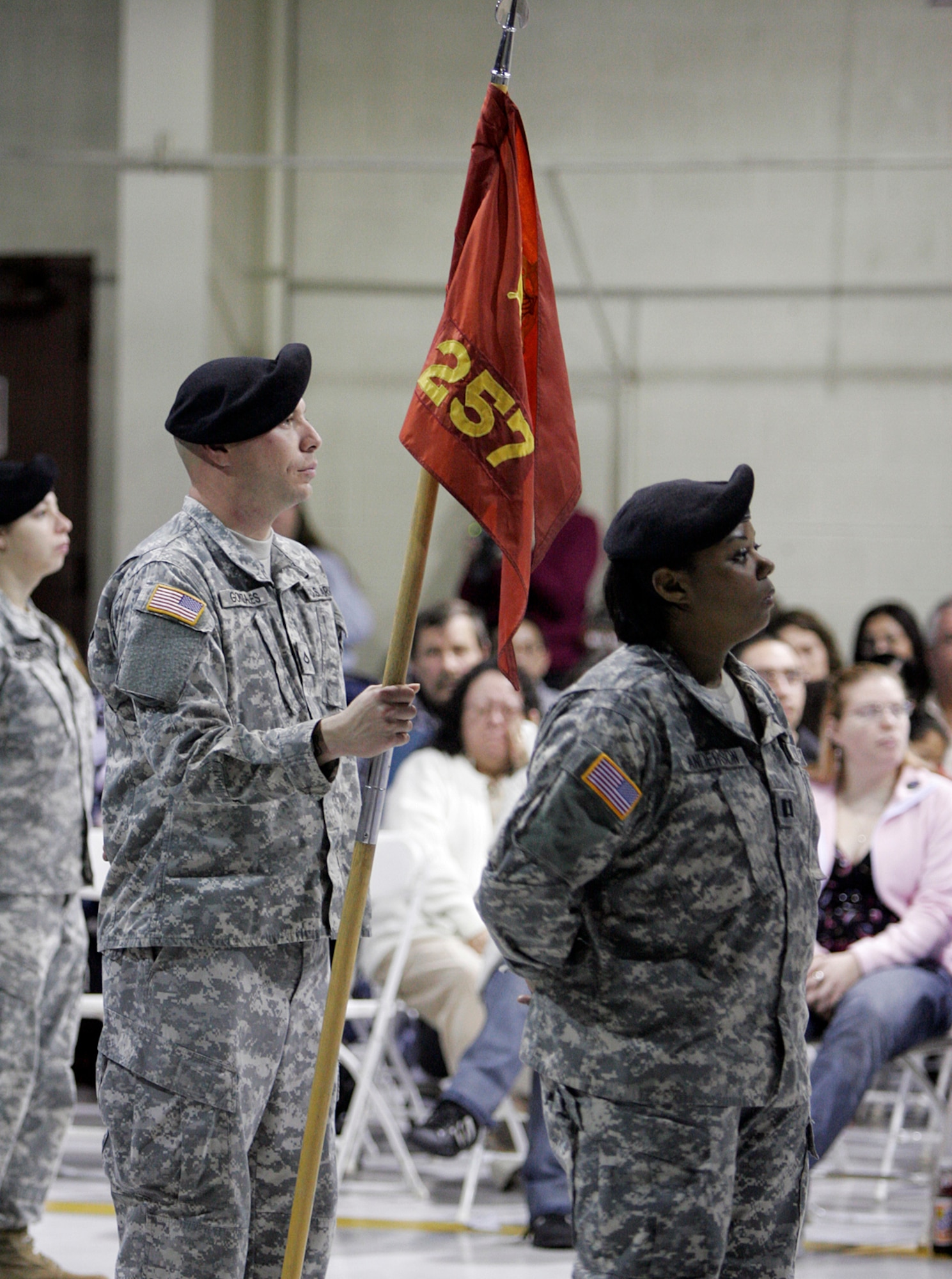 U.S. Army Pfc. Elias H. Gonzales Jr., 257th Transportation Company (left) and Capt. Valeria Anderson, 257th commander (right), receive their official orders during a pre-deployment ceremony held here, Jan. 11. More than 100 soldiers from the 257th are scheduled to deploy Jan. 13 to forward operating locations in support of Operation Iraqi Freedom. (U.S. Air Force photo by Staff Sgt. Jacob R. McCarthy)