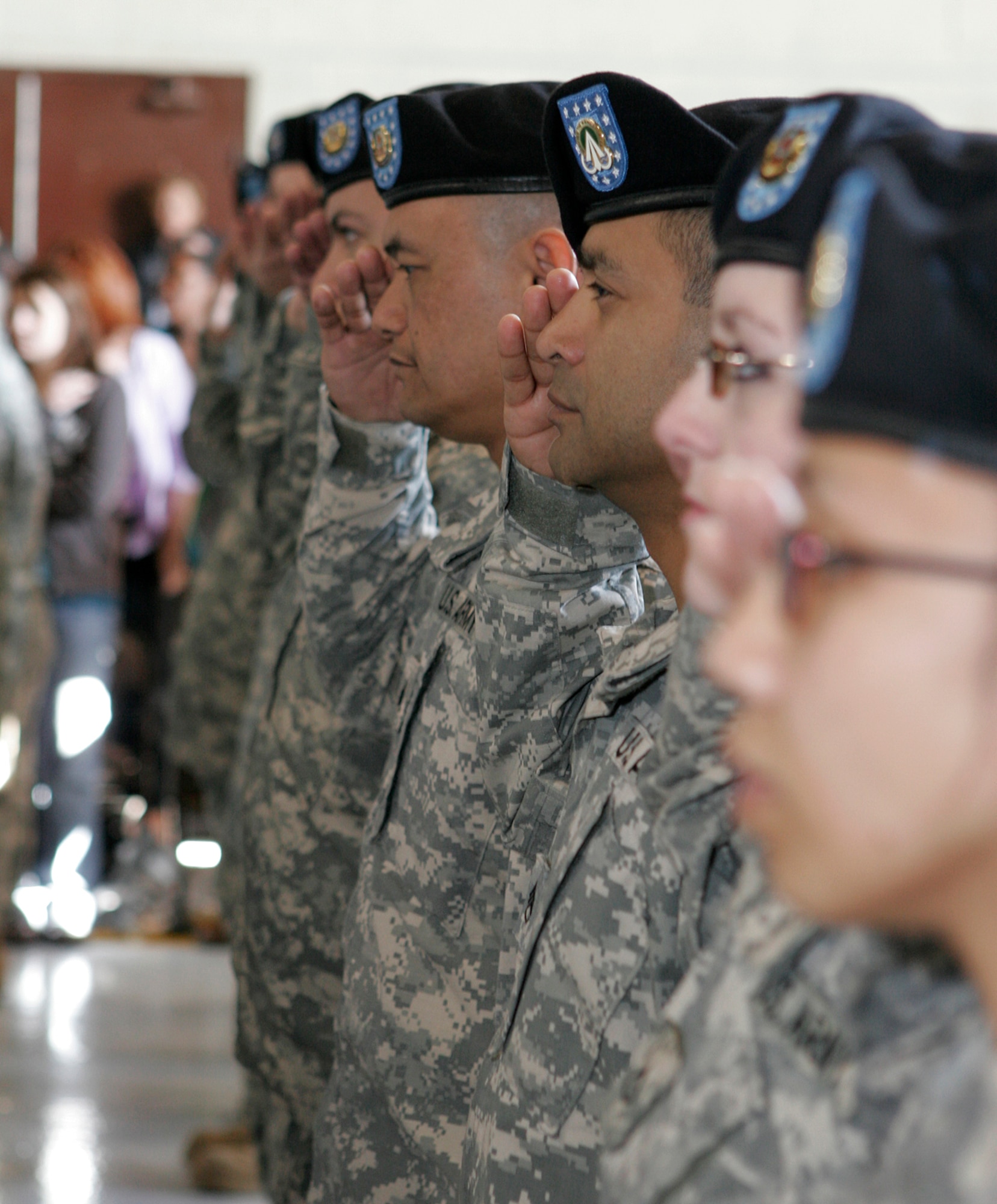 Soldiers from the U.S. Army’s 257th Transportation Company salute the colors during a pre-deployment ceremony held here, Jan. 11. More than 100 soldiers from the 257th are scheduled to deploy Jan. 13 to forward operating locations in support of Operation Iraqi Freedom. (U.S. Air Force photo by Staff Sgt. Jacob R. McCarthy)